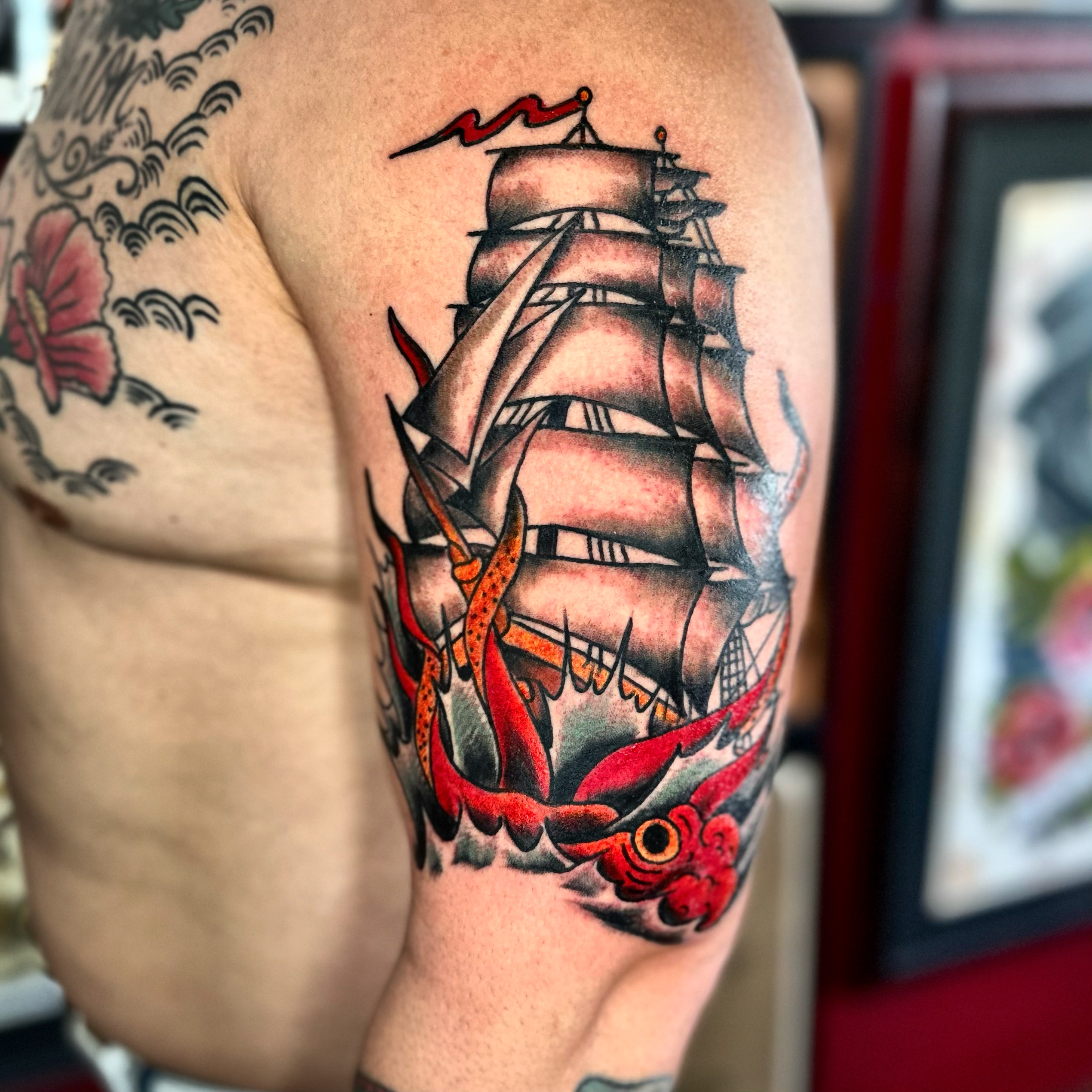 Tattoo of a ship and a squid from top Dallas tattoo shop