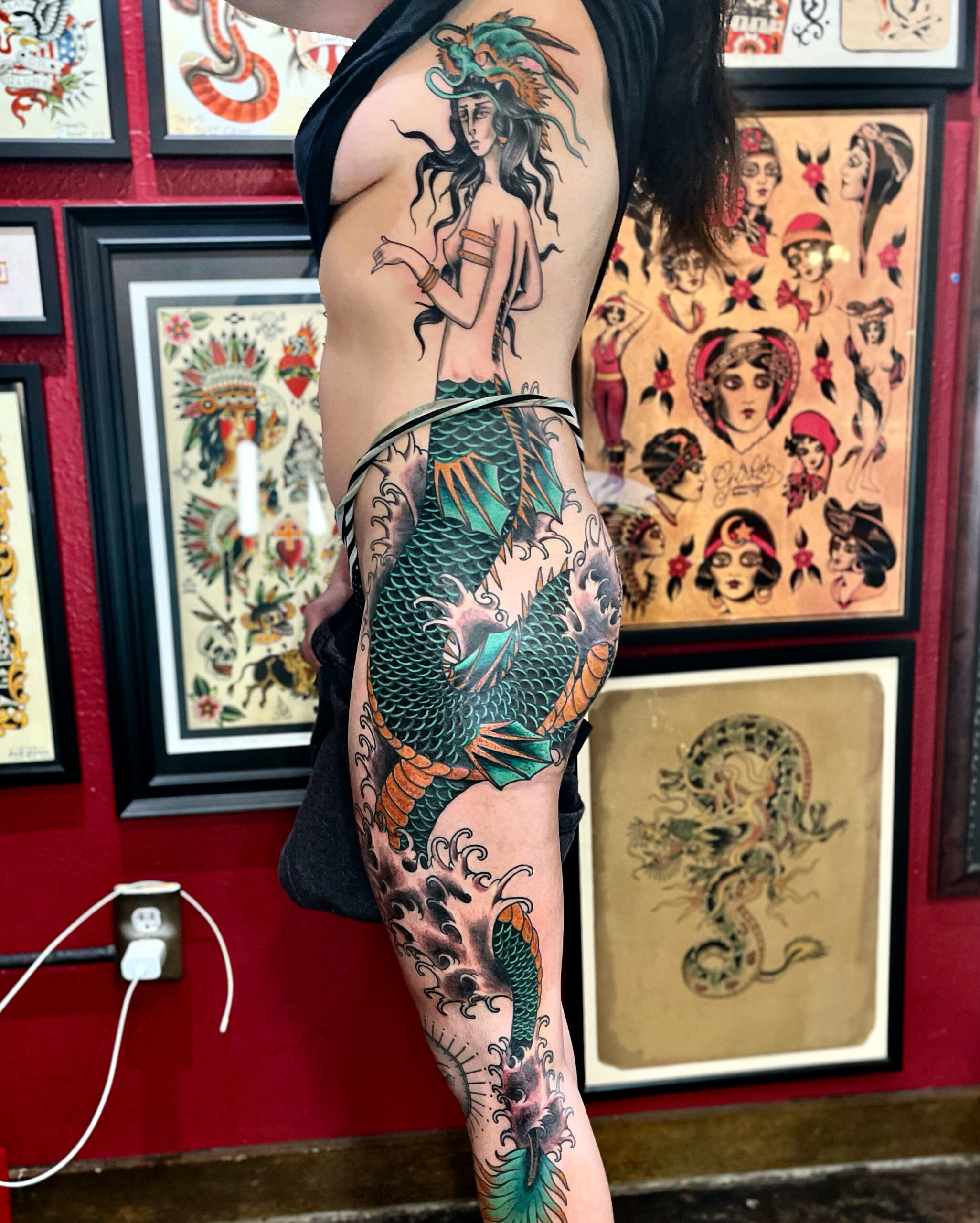 Tattoo of a mermaid down a woman's side