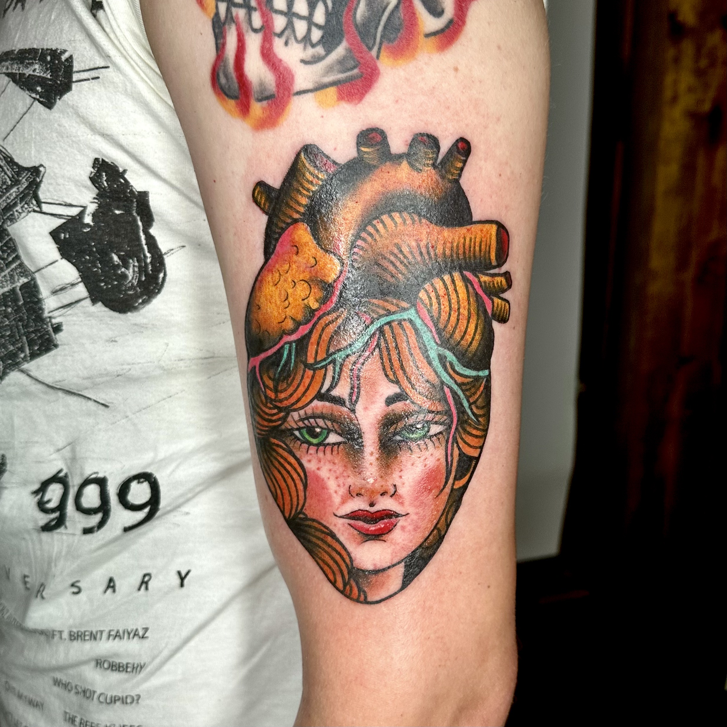 Face and heart tattoo