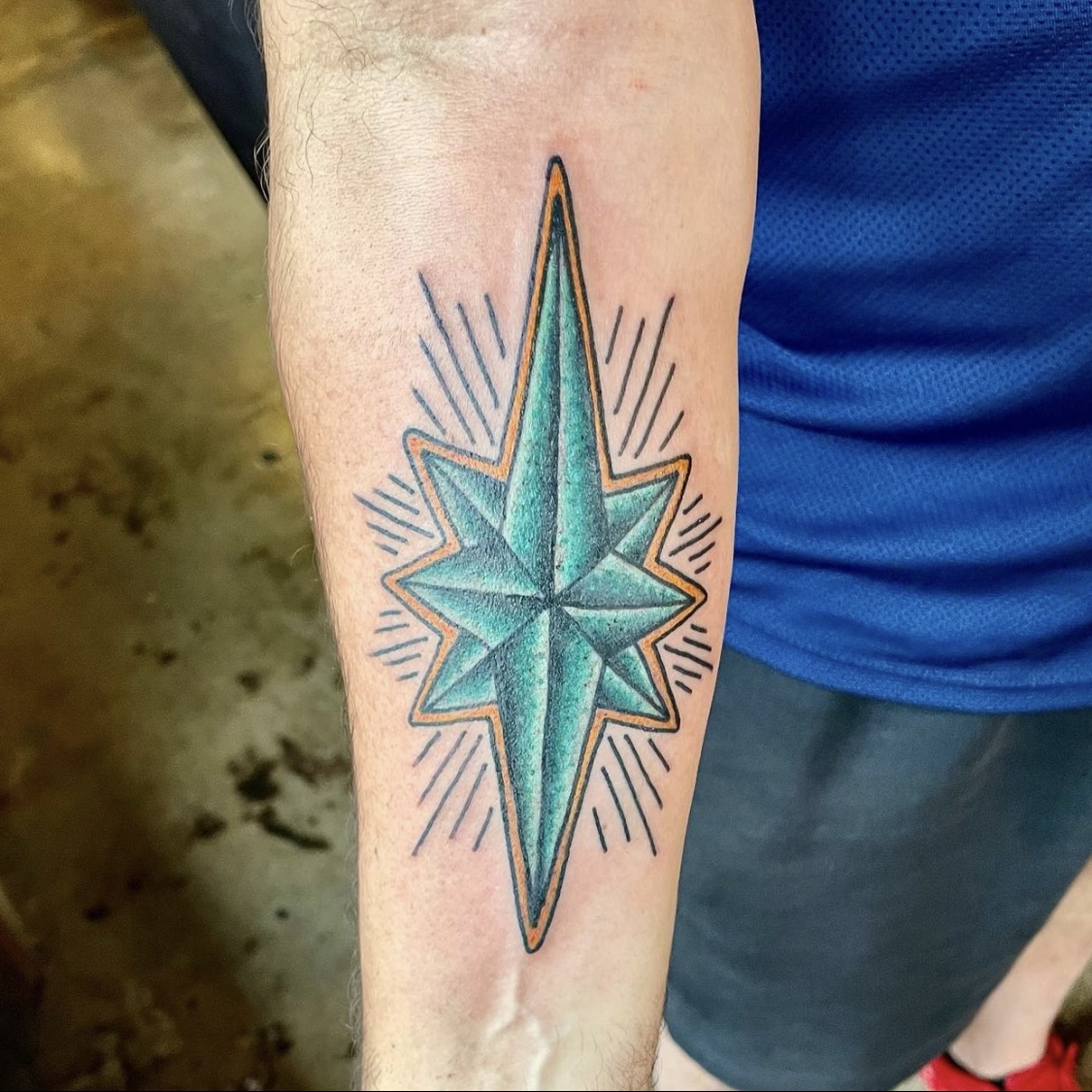 Large tattoo of a green star from best tattoos in dallas
