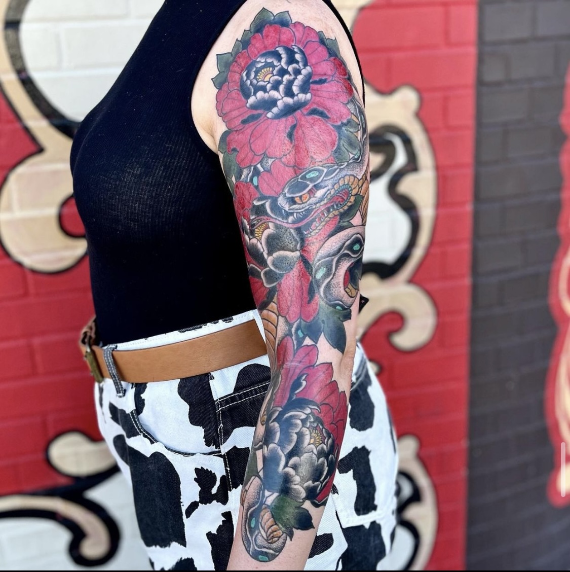 Large flower tattoo on a woman's arm from Dallas tattoo artist