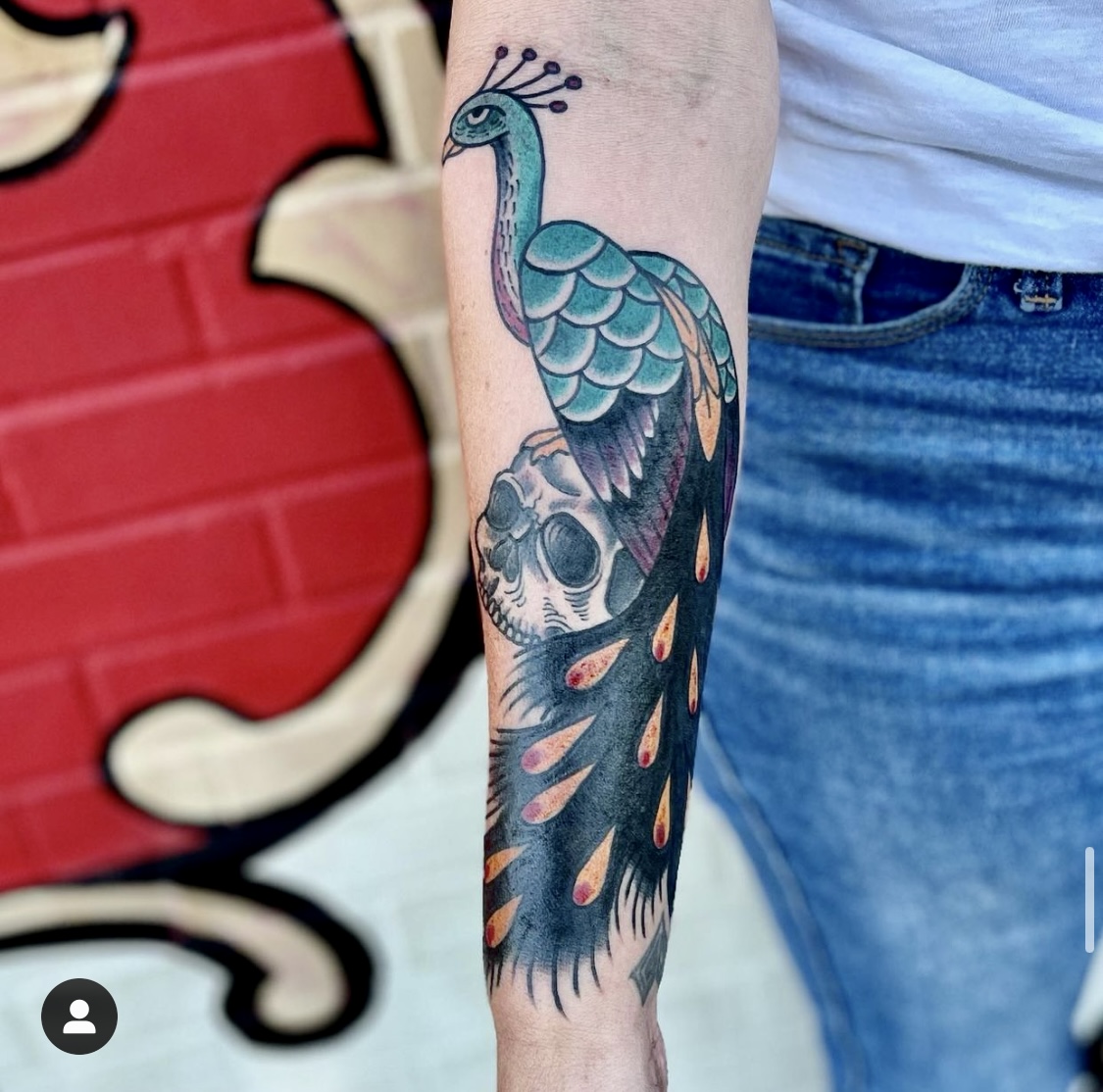 Tattoo of a skull and a peacock from dallas tattoo artists
