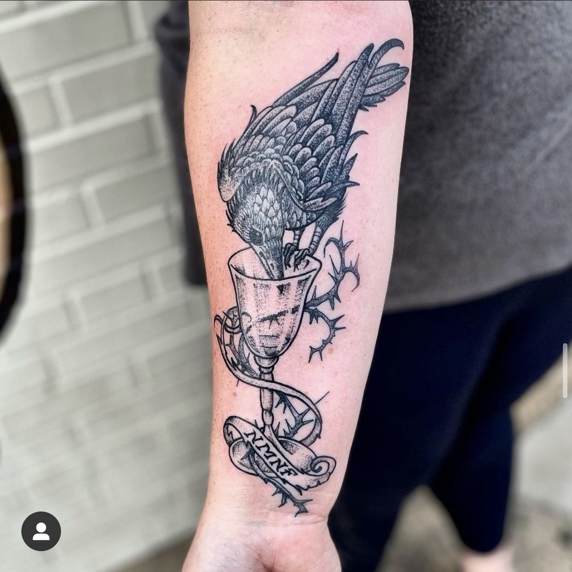 Tattoo of a crow and a cup from top Dallas tattoo artist