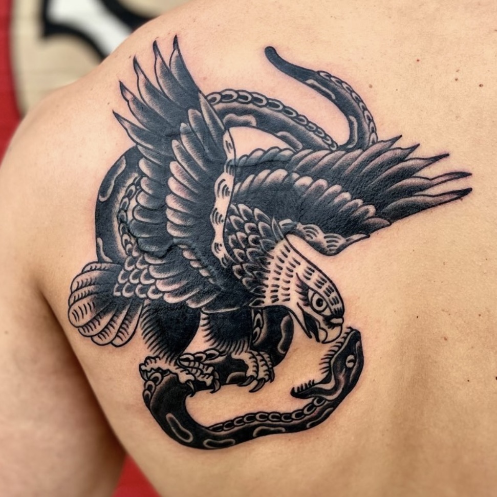 Tattoo of an eagle and a snake from top Dallas tattoo artist