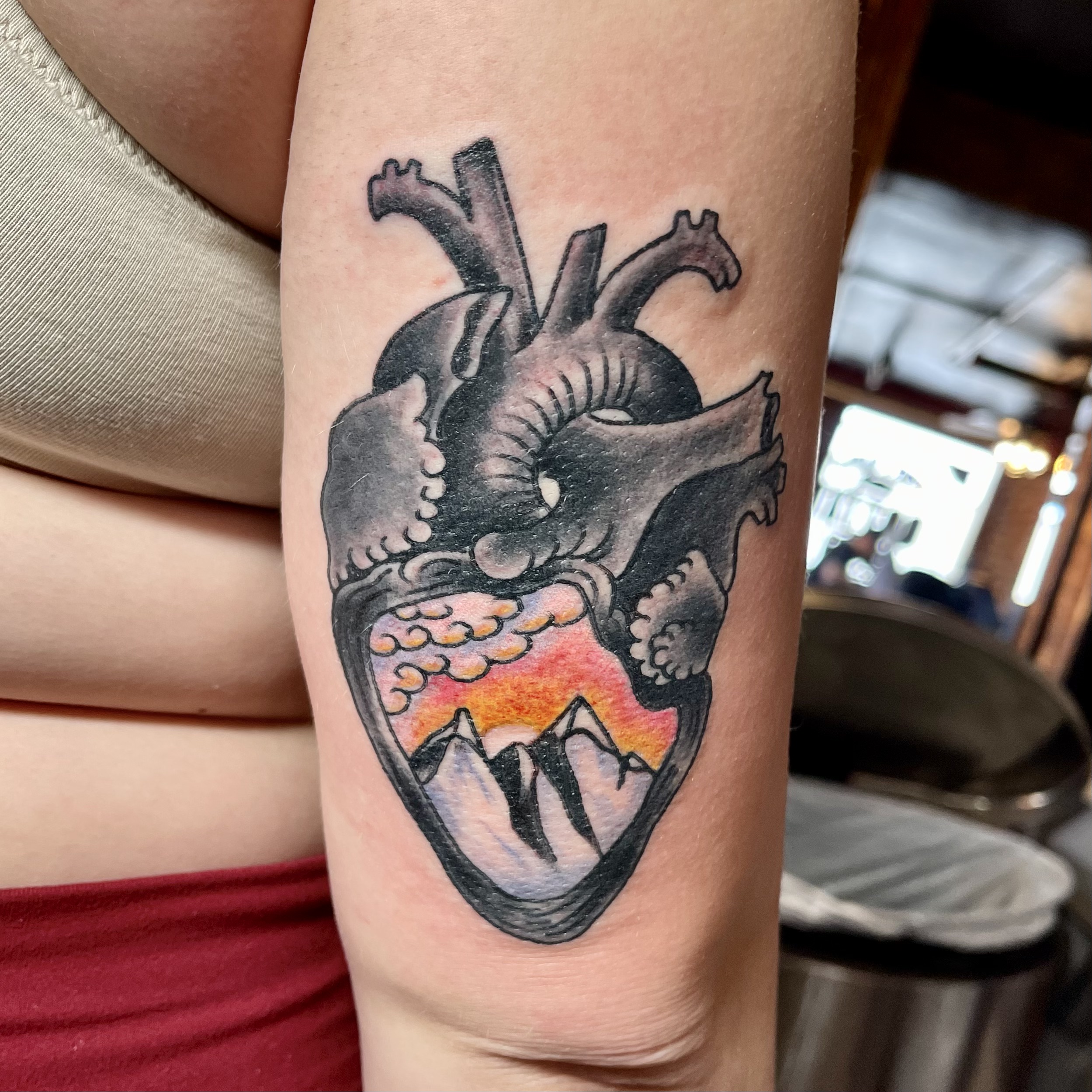 tattoo of an anatomical heart on a woman's arm