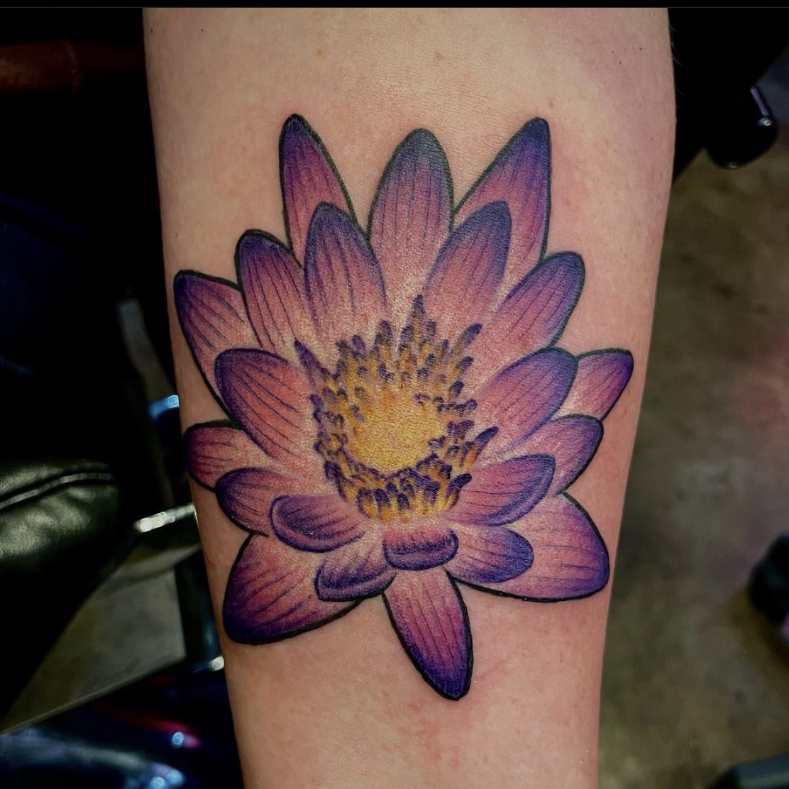 Tattoo of a purple flower from the top Dallas tattoo artist