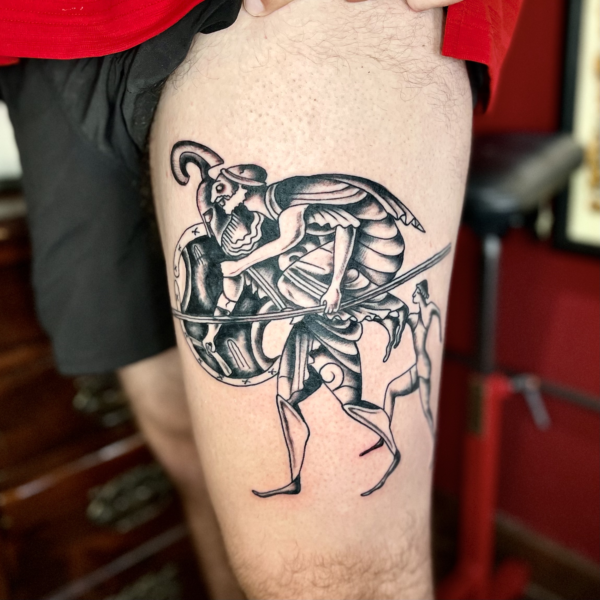 Tattoo of a spartan on a man's leg