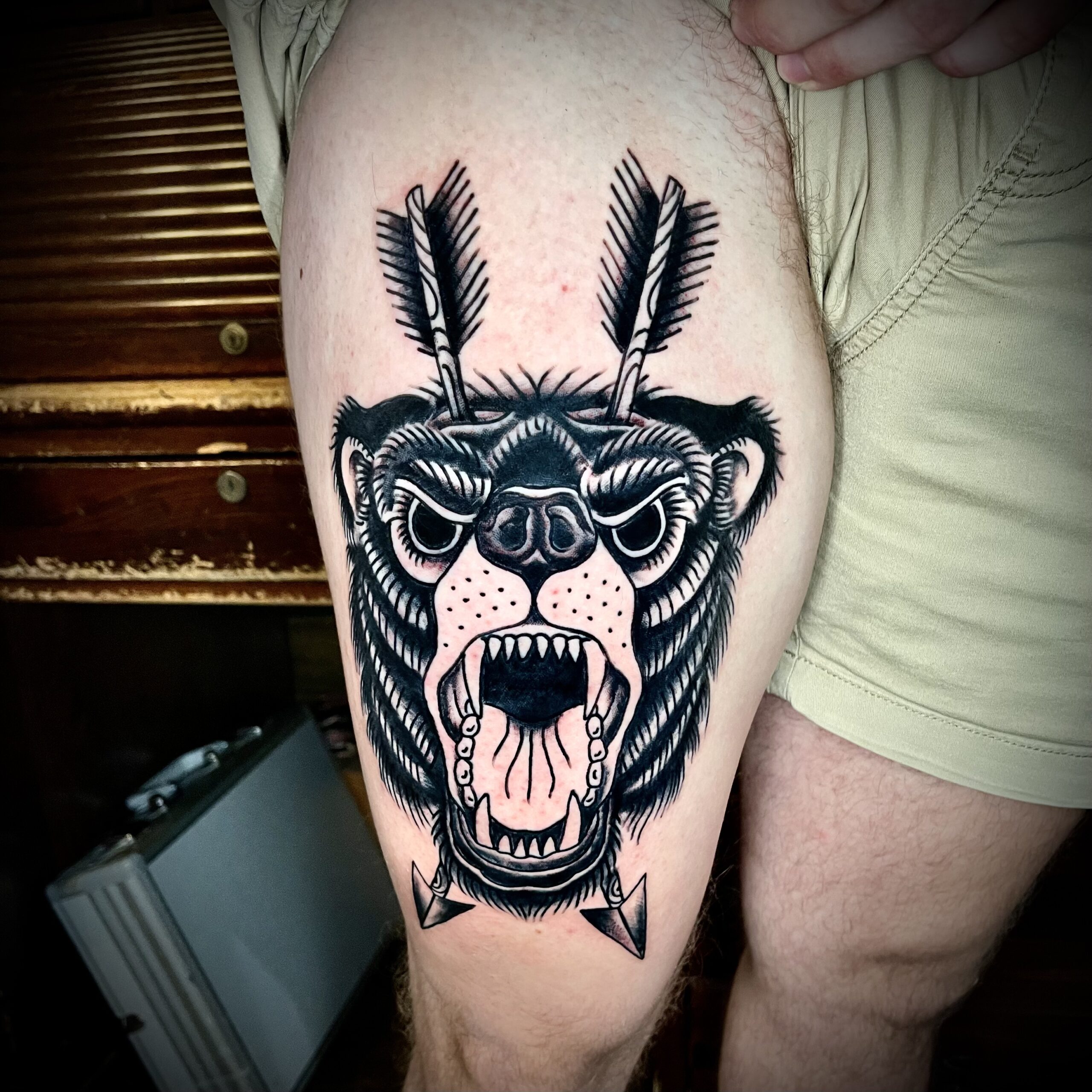 Tattoo of a bear on a man's leg
