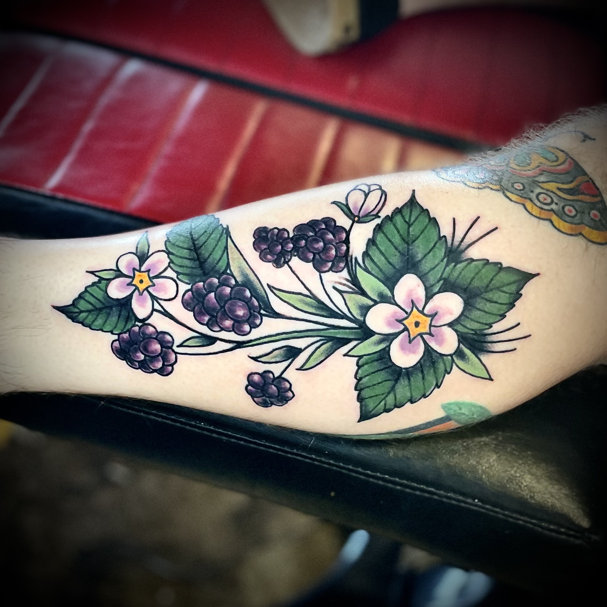Tattoo of blackberries and flowers