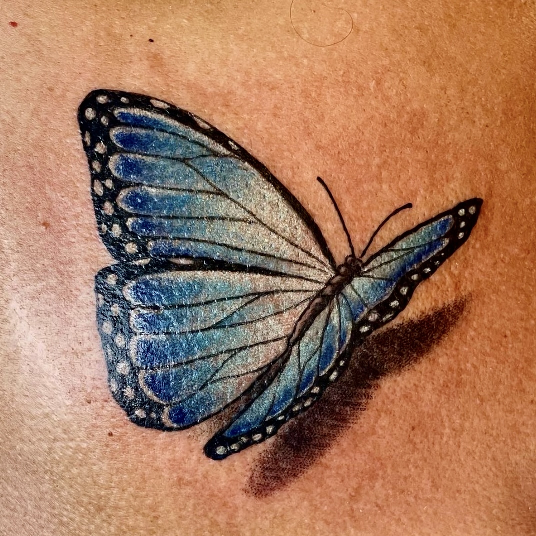 Tattoo of a blue butterfly from top artist in Dallas TX
