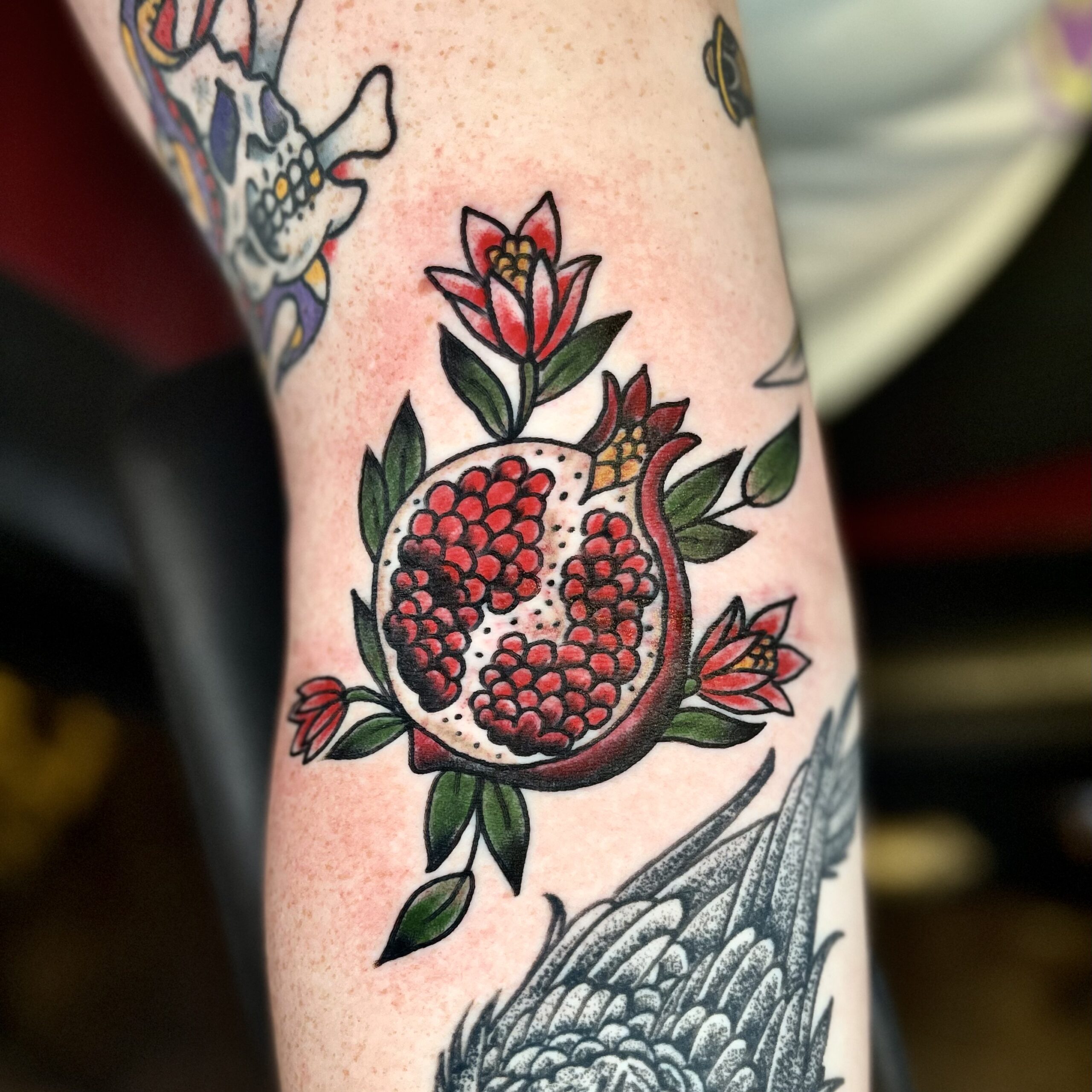 Tattoo of a pomegranate from Dallas tattoo artist