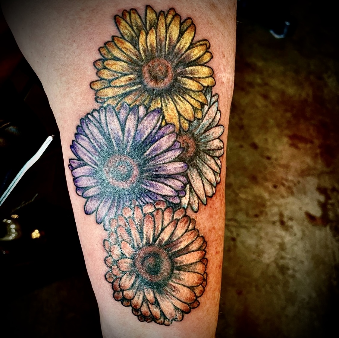 Tattoo of colorful flowers from top tattoo shop in Dallas Texas