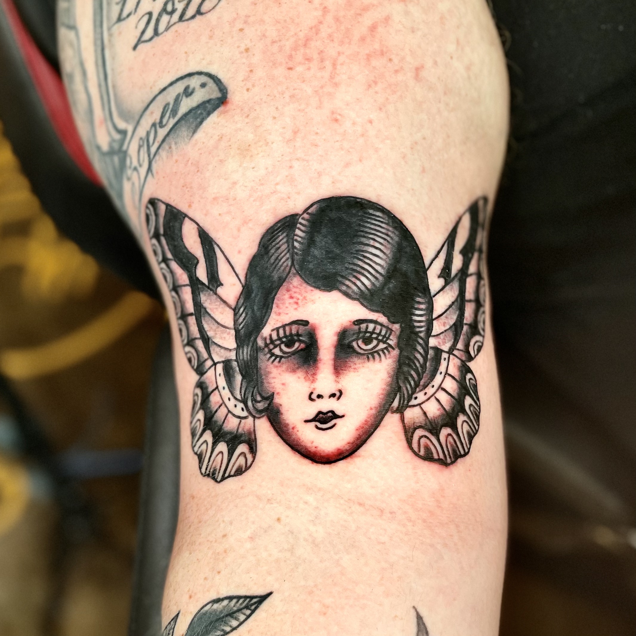 Tattoo of a woman and butterfly wings