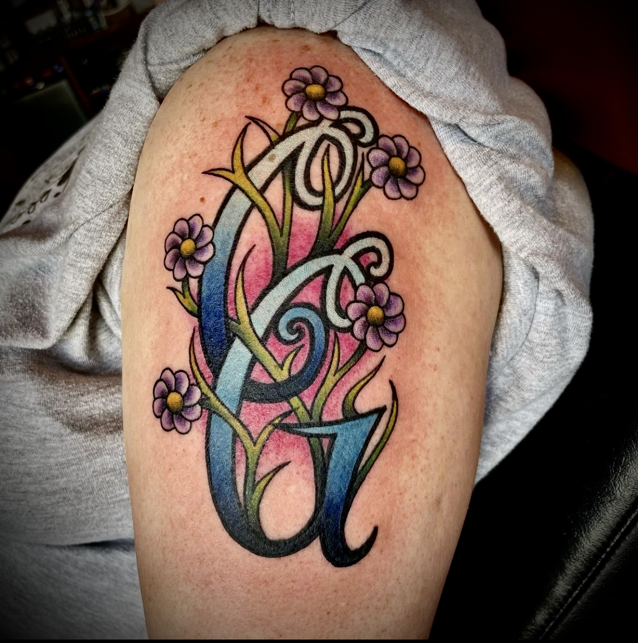 Tattoo of initials and flowers from Dallas tattoo artist