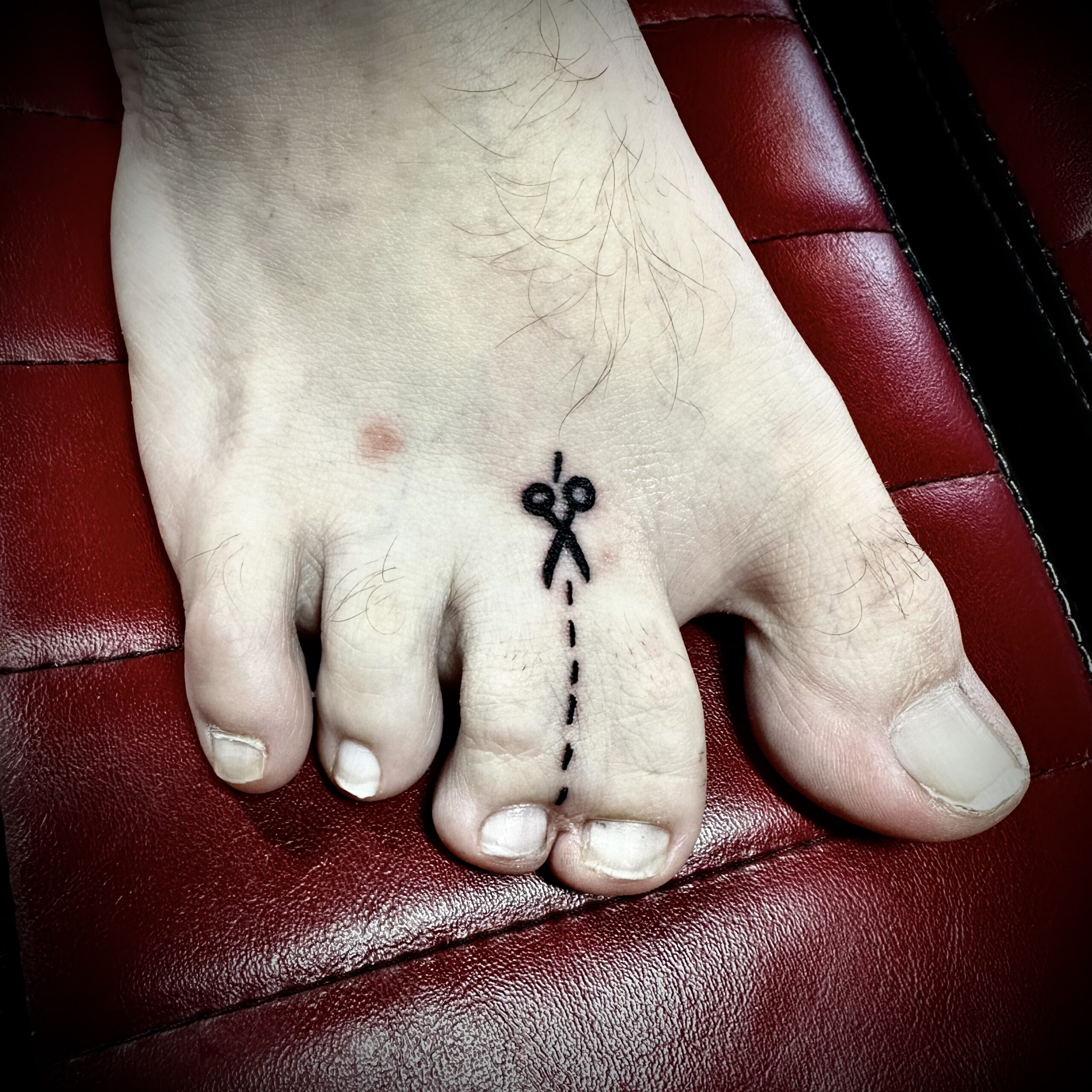 tattoo of scissors on a foot