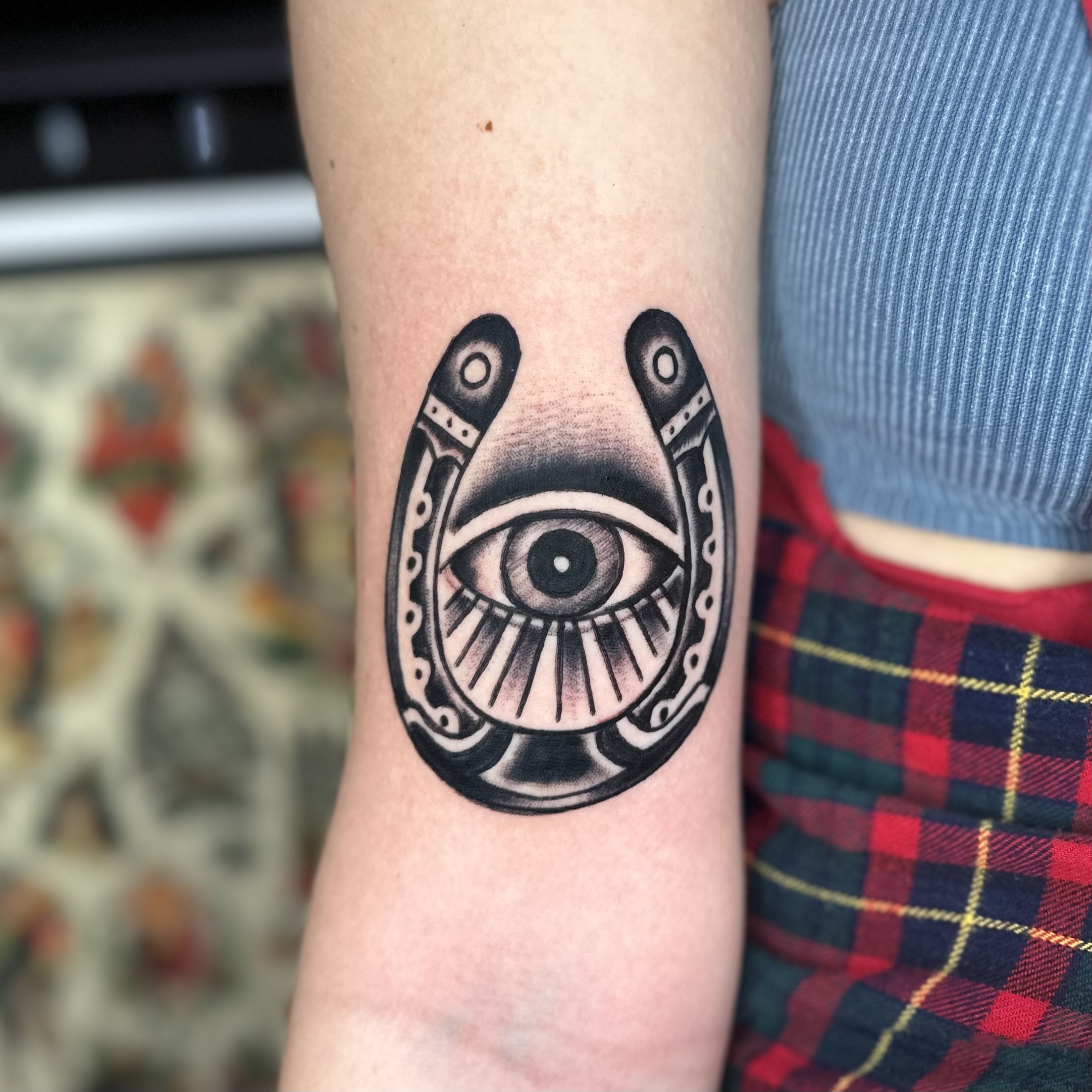 tattoo of a horseshoe and an eye