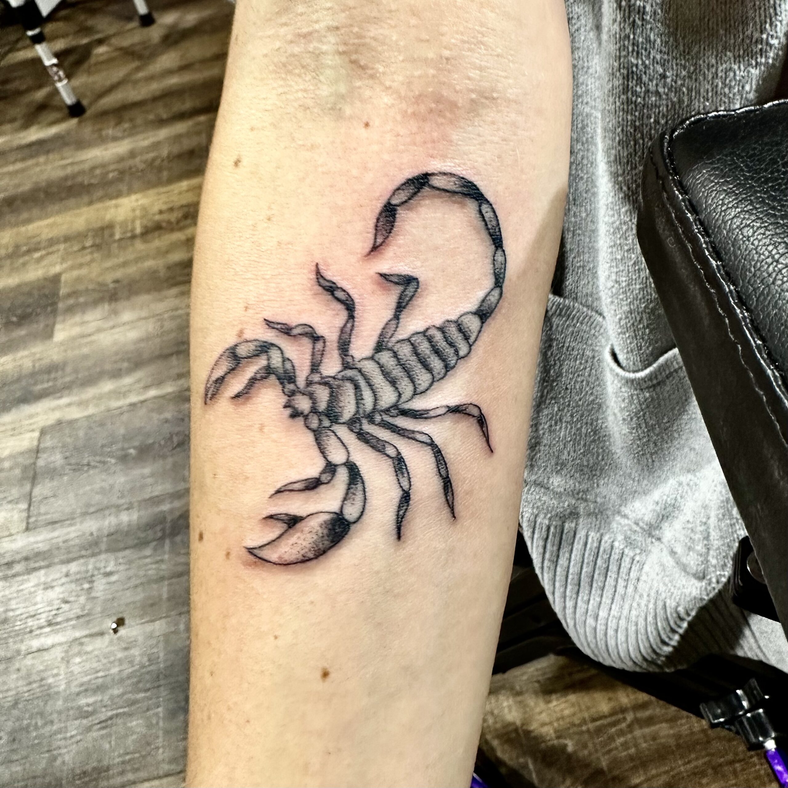Tattoo of a black scorpion