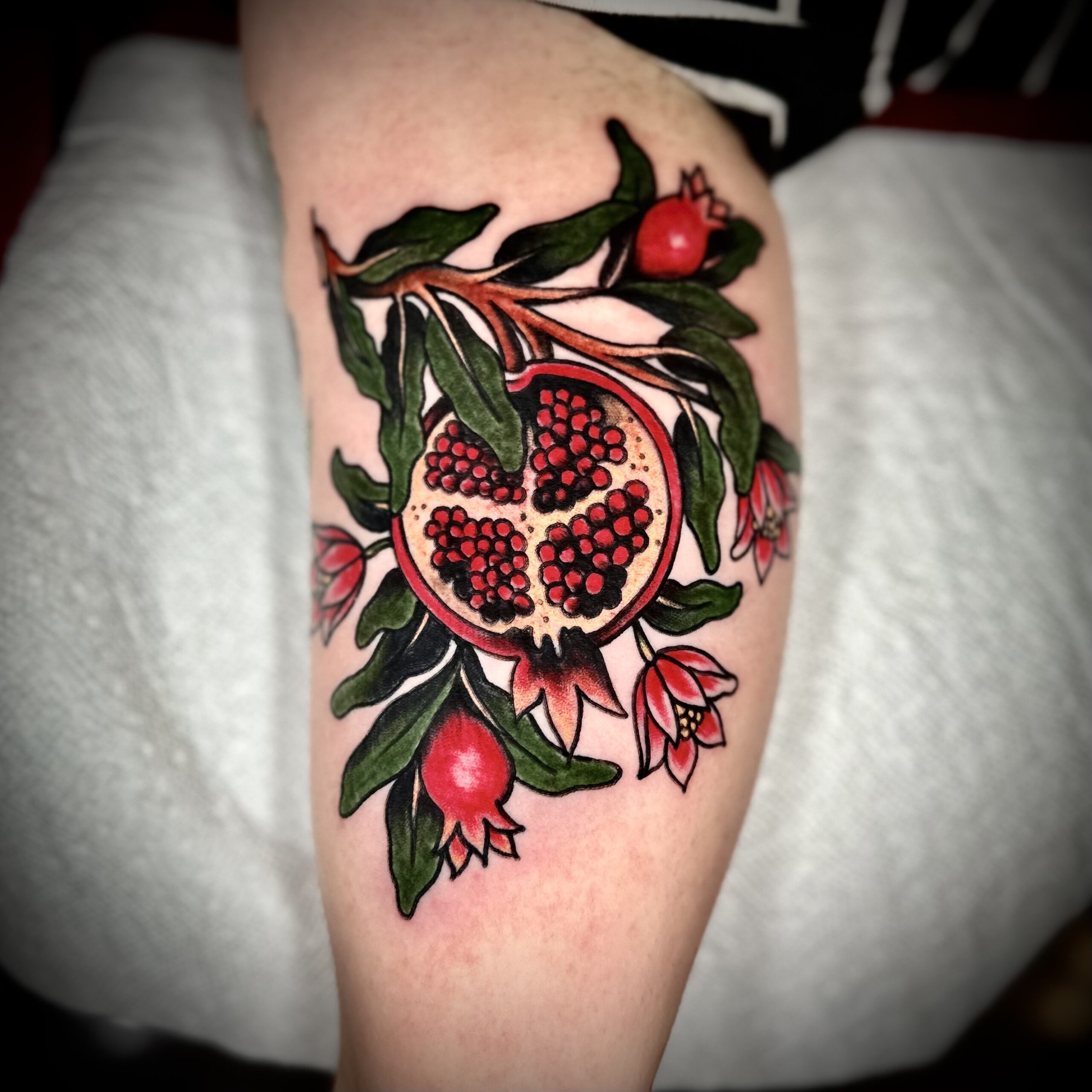 tattoo of a pomegranate and flowers