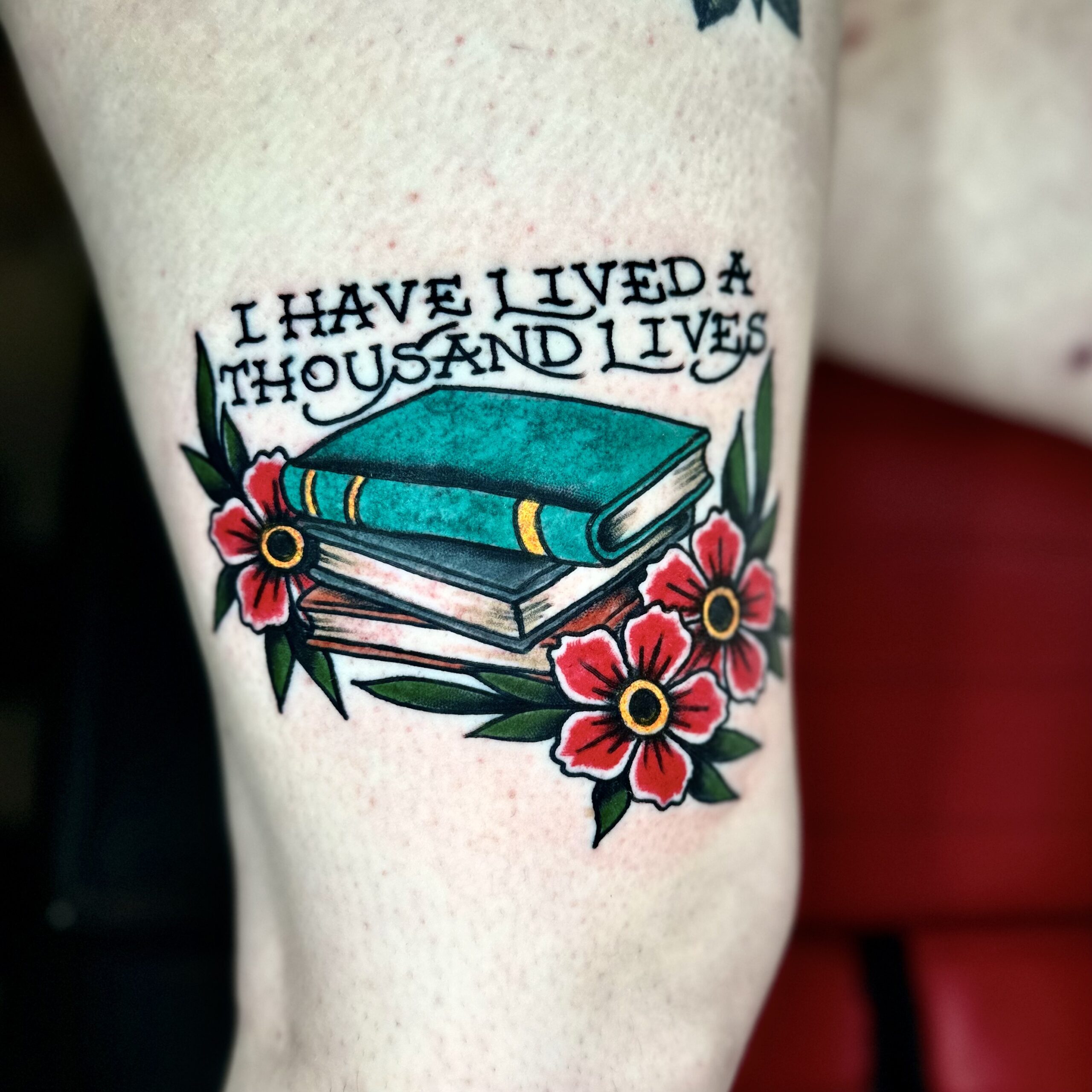 tattoo of books and some flowers from DFW tattoo shop
