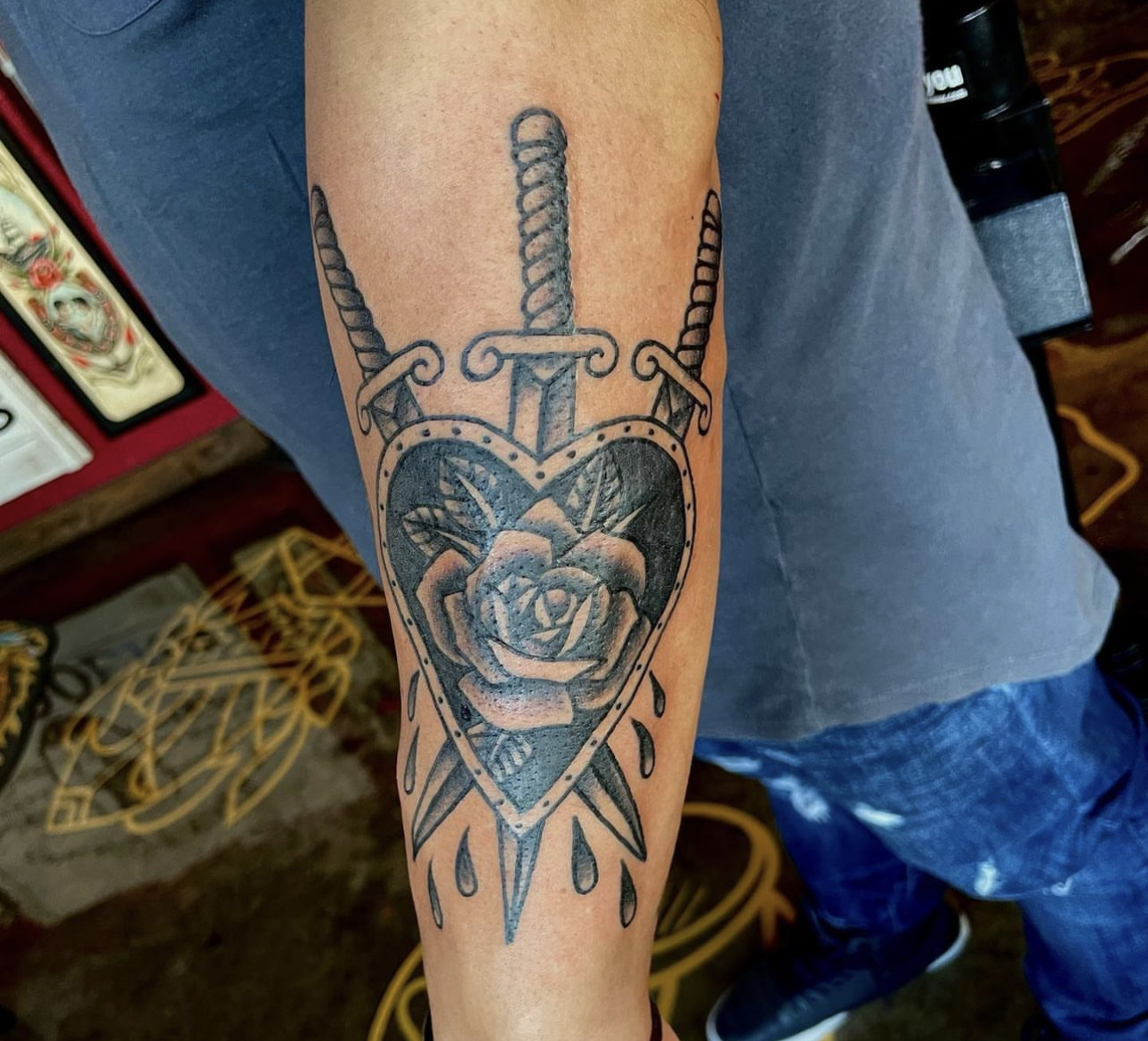 tattoo of a heart and swords