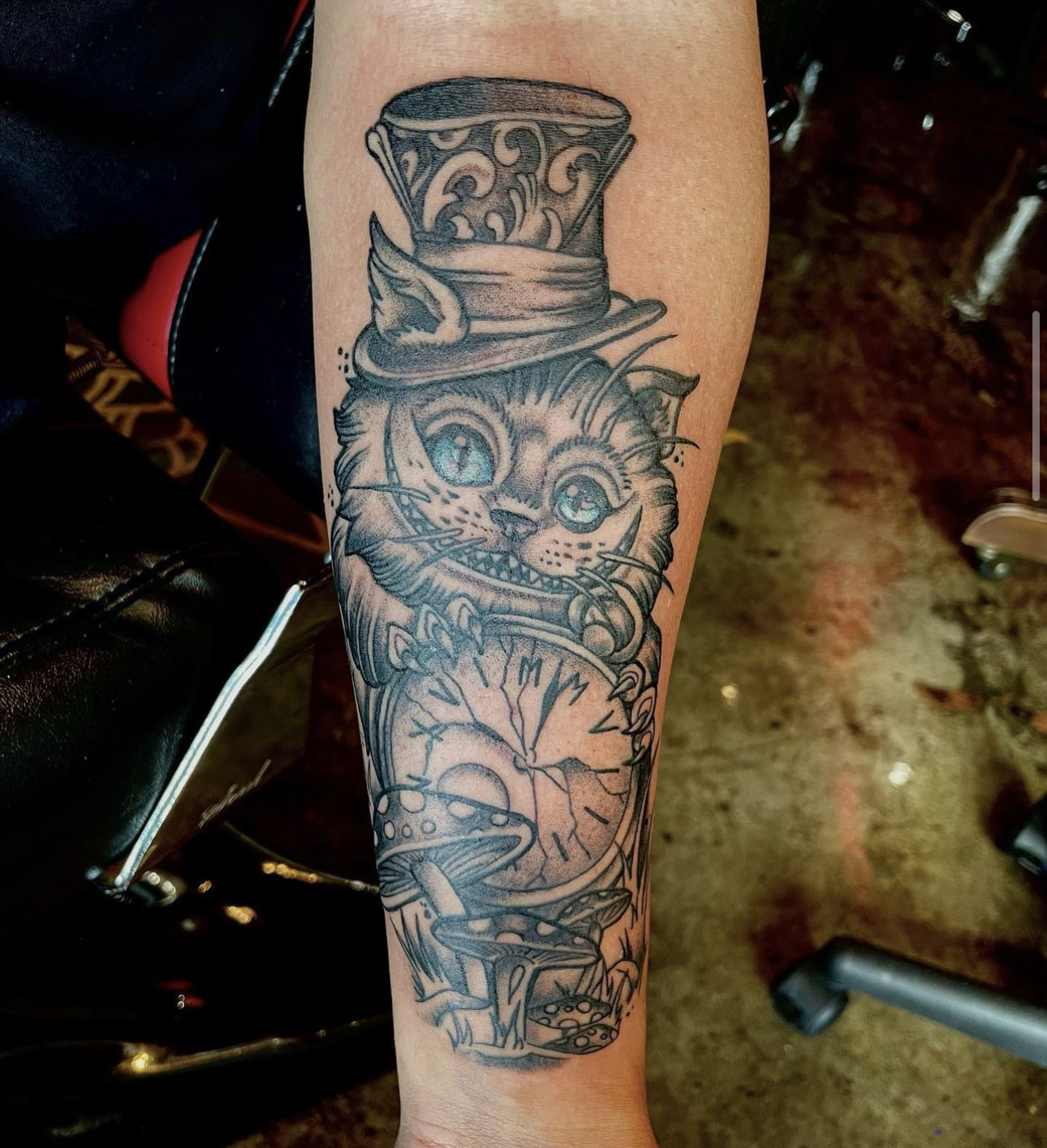 tattoo of a cat with a hat and a clock