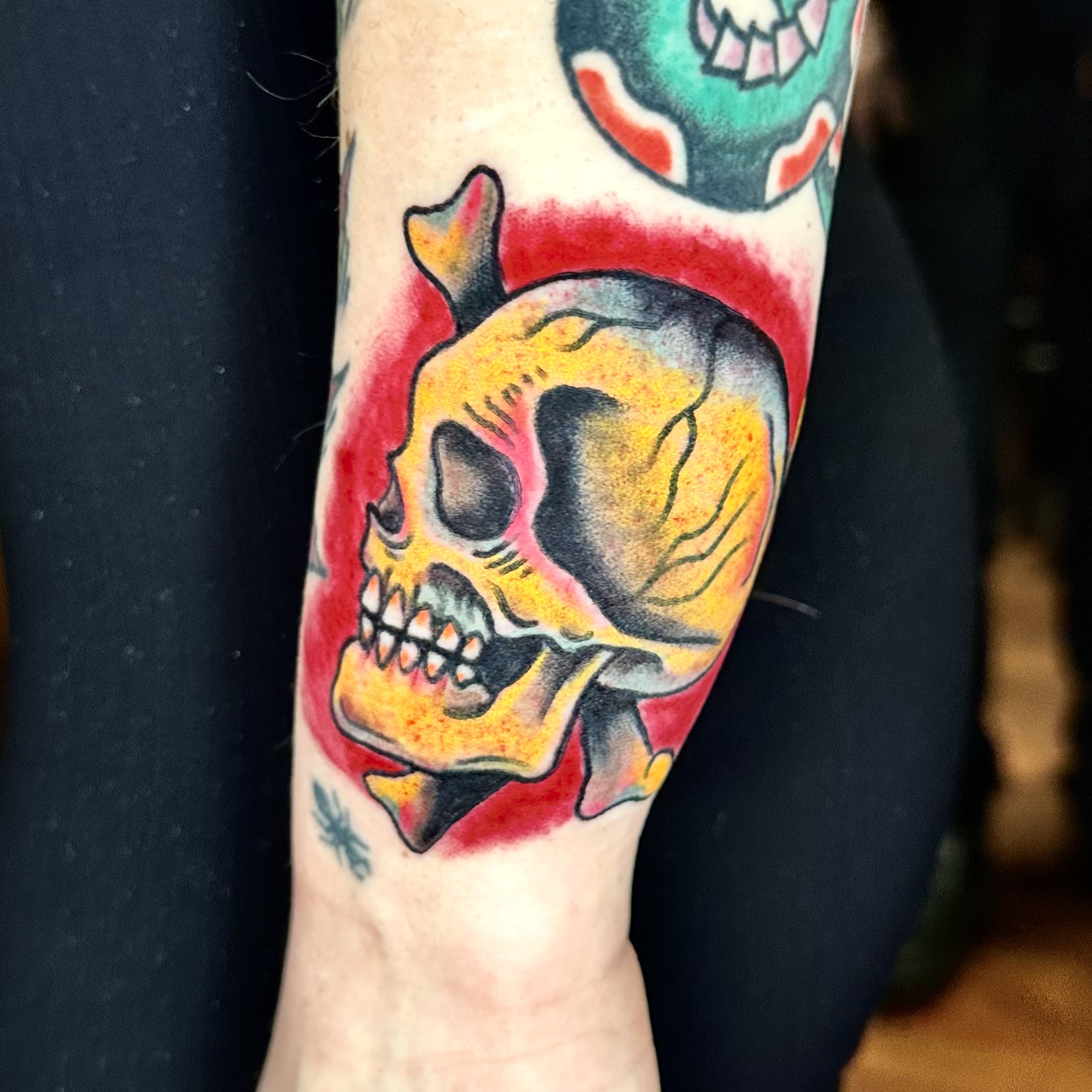 Tattoo of a skull and bones on an arm