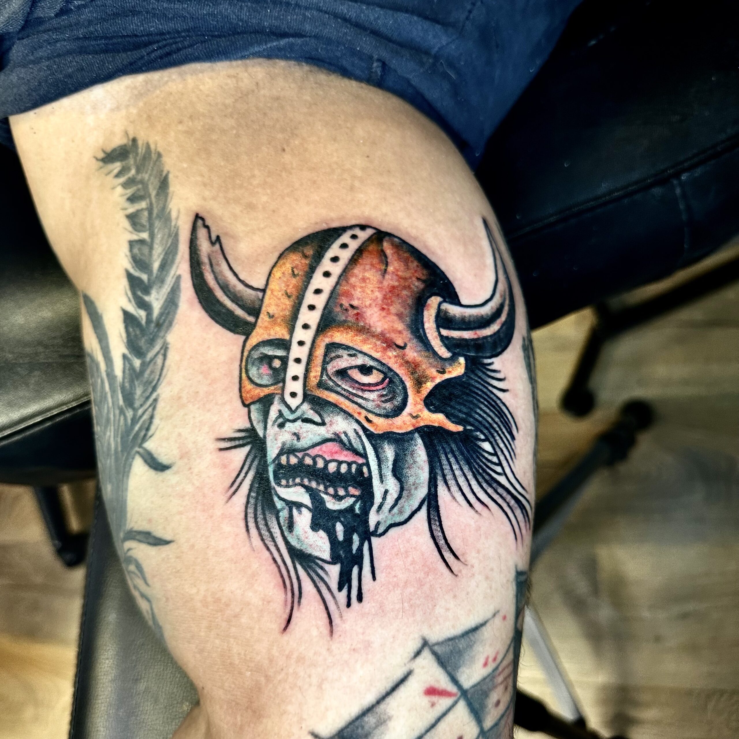 Tattoo of a zombie in a horned helmet