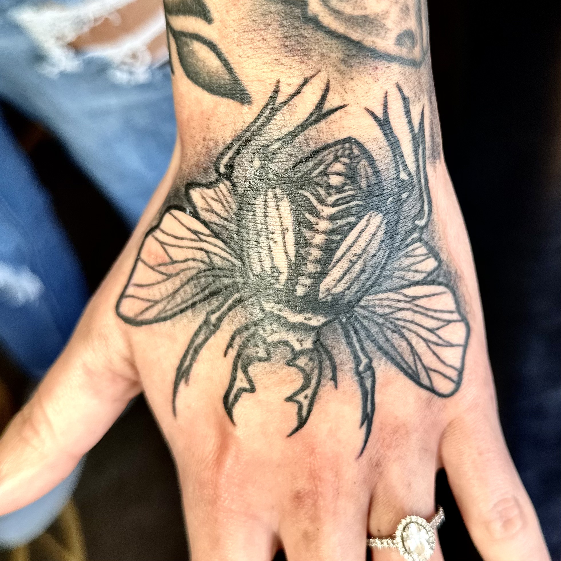 Tattoo of a bug on a hand from Dallas tattoo shop