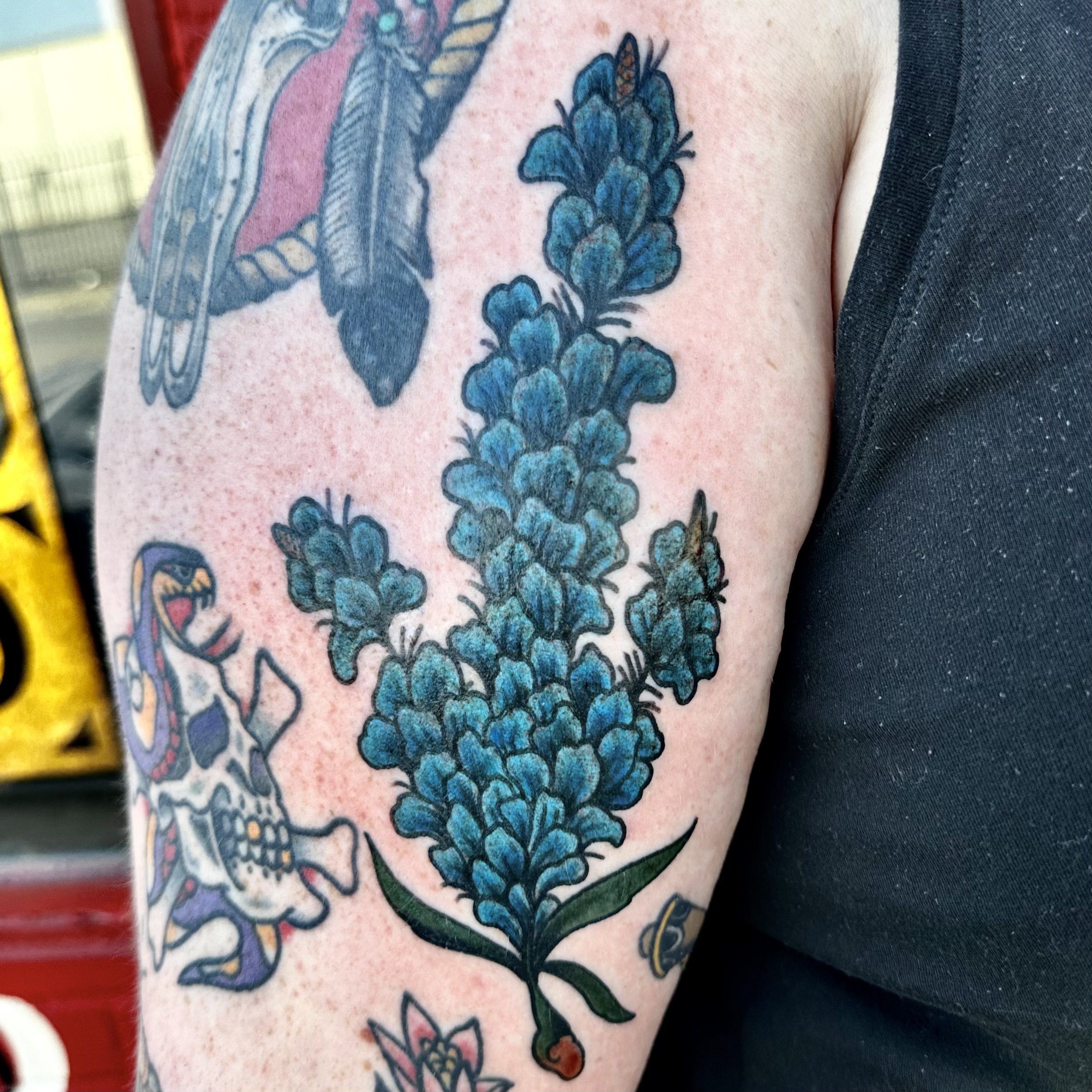 Tattoo of blue flowers from professional tattoo artist in Dallas