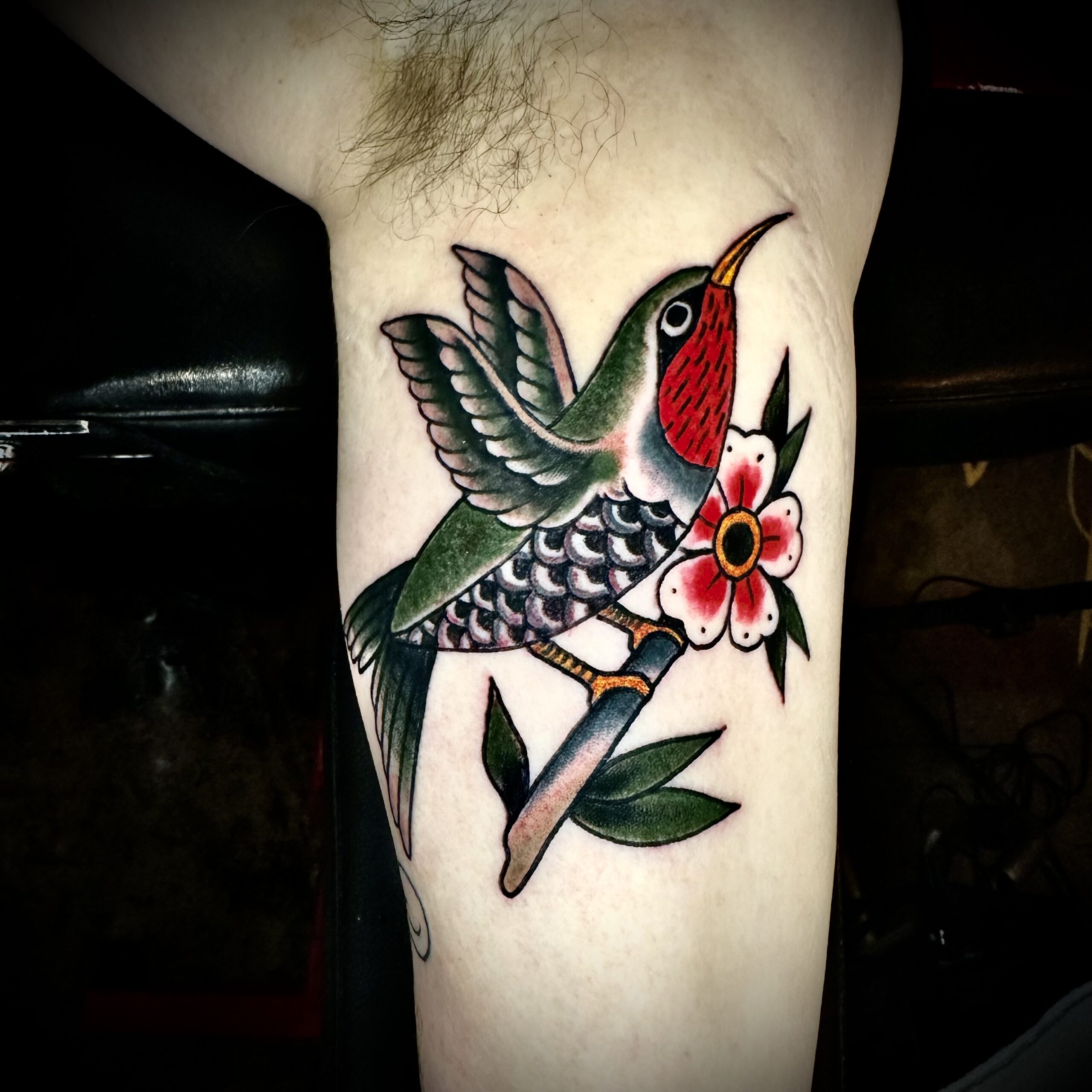 Tattoo of a bird and a flower