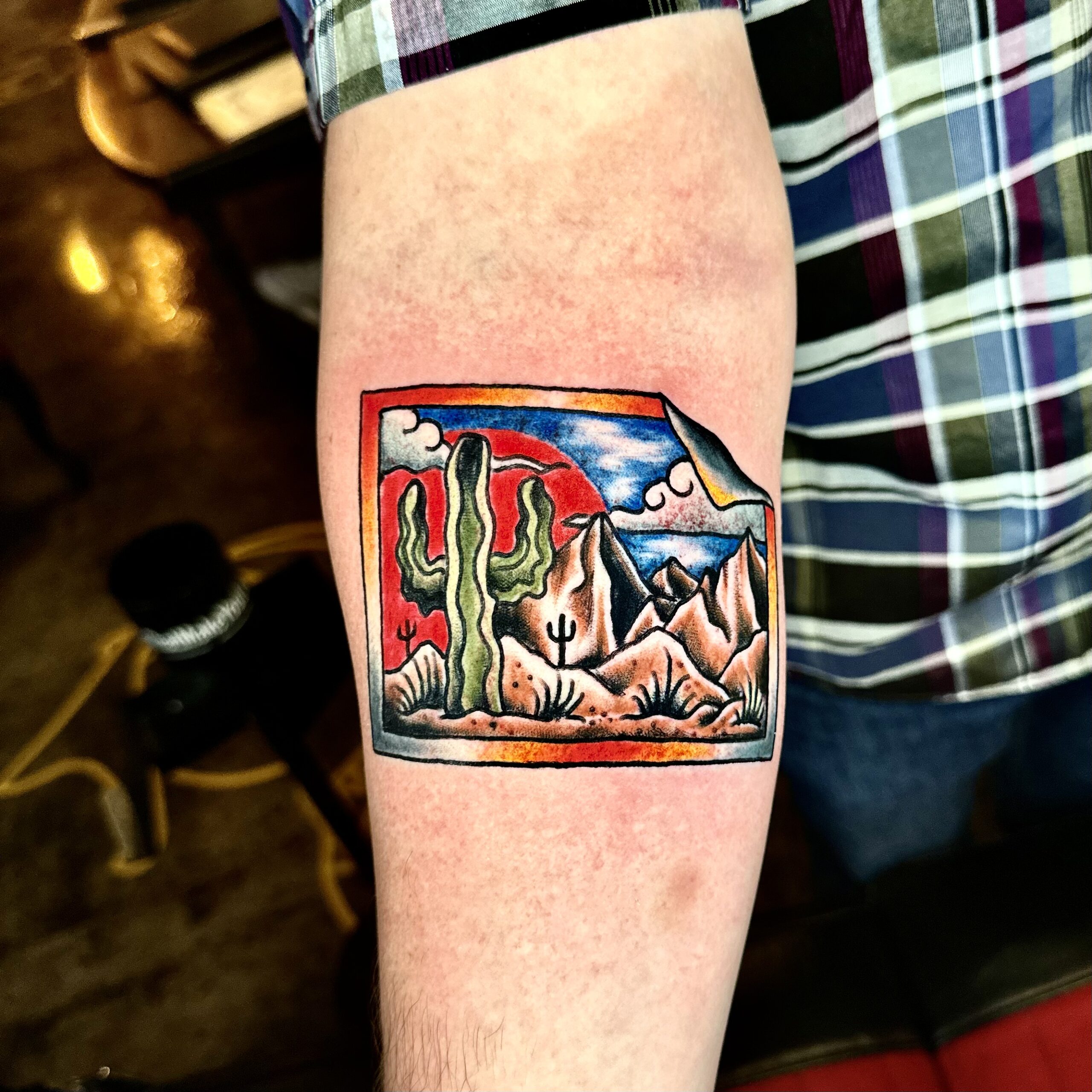 Tattoo of a picture of a desert and mountains
