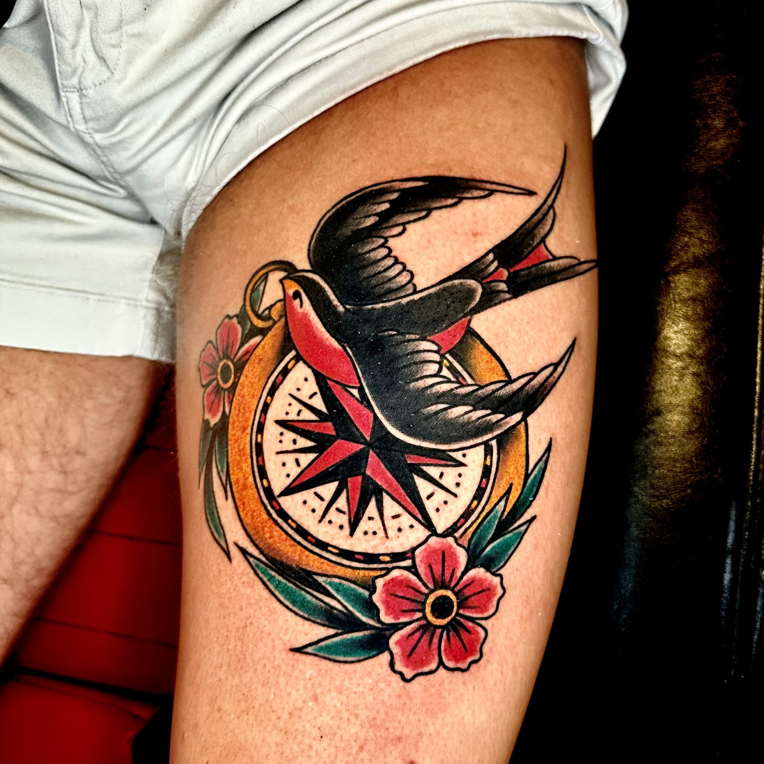 Tattoo of a bird and a compass
