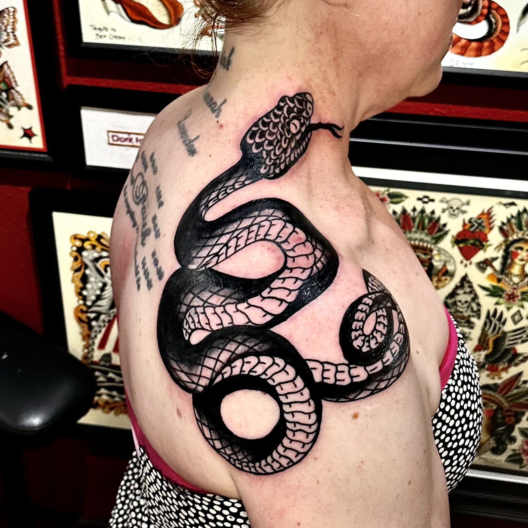 Tattoo of a snake on a woman's neck