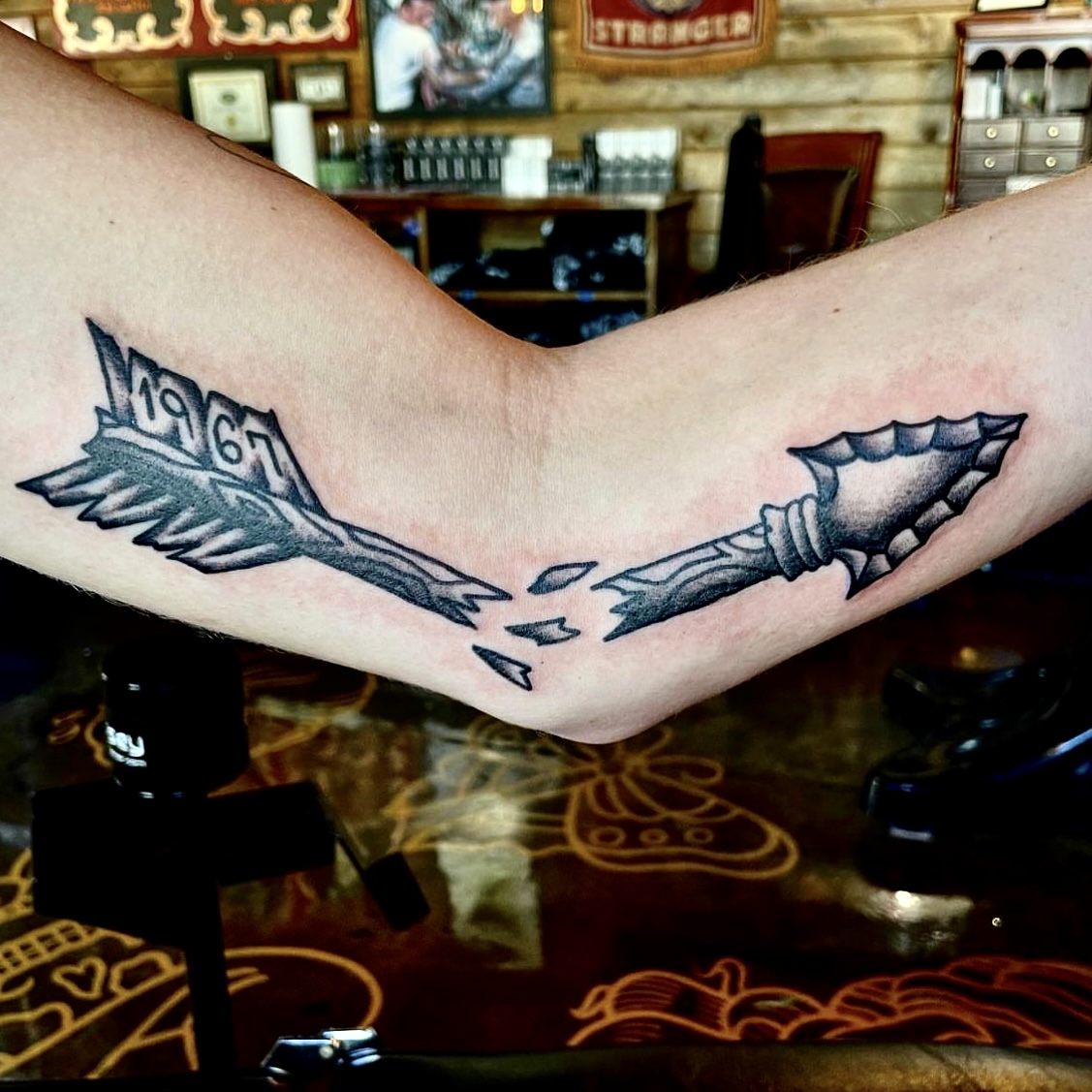 Tattoo of a broken arrow