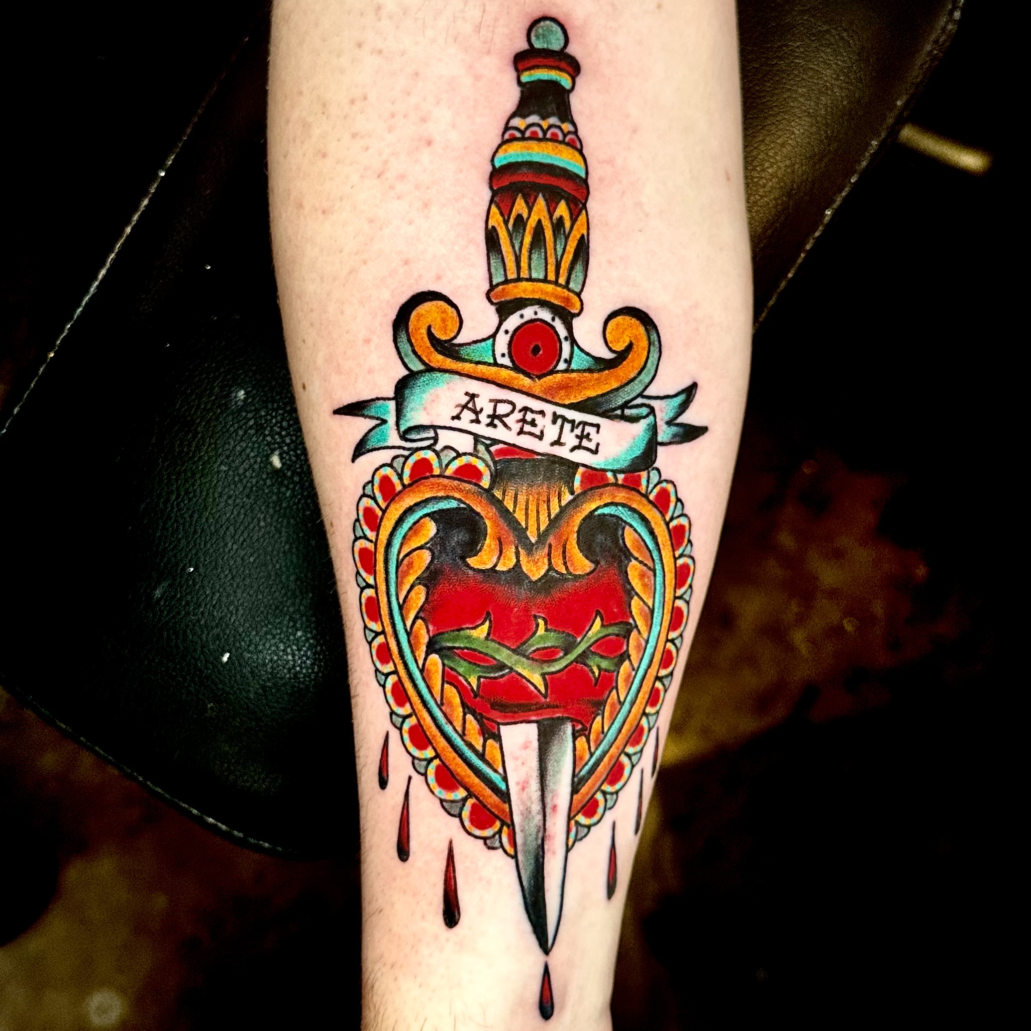 tattoo of a sword through a heart