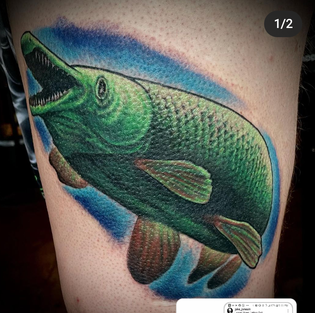 Tattoo of a green fish from dallas tattoo artists