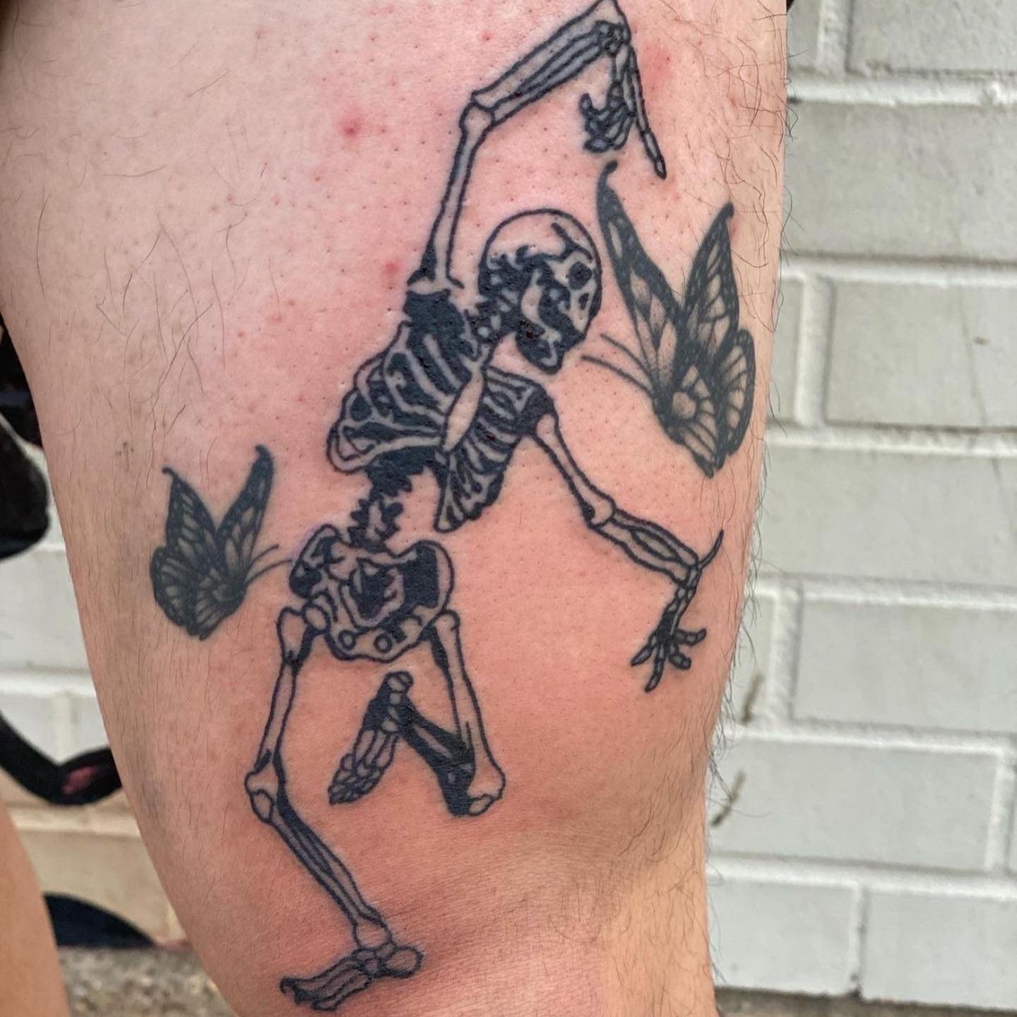tattoo of a skeleton on a man's leg