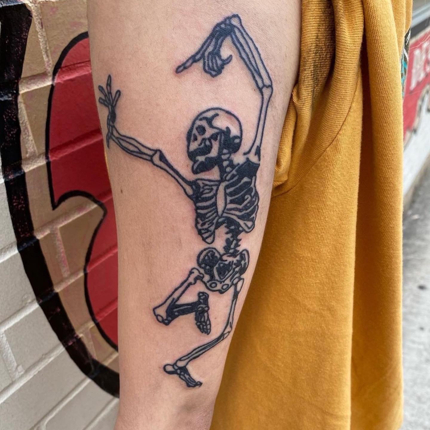 tattoo of a dancing skeleton