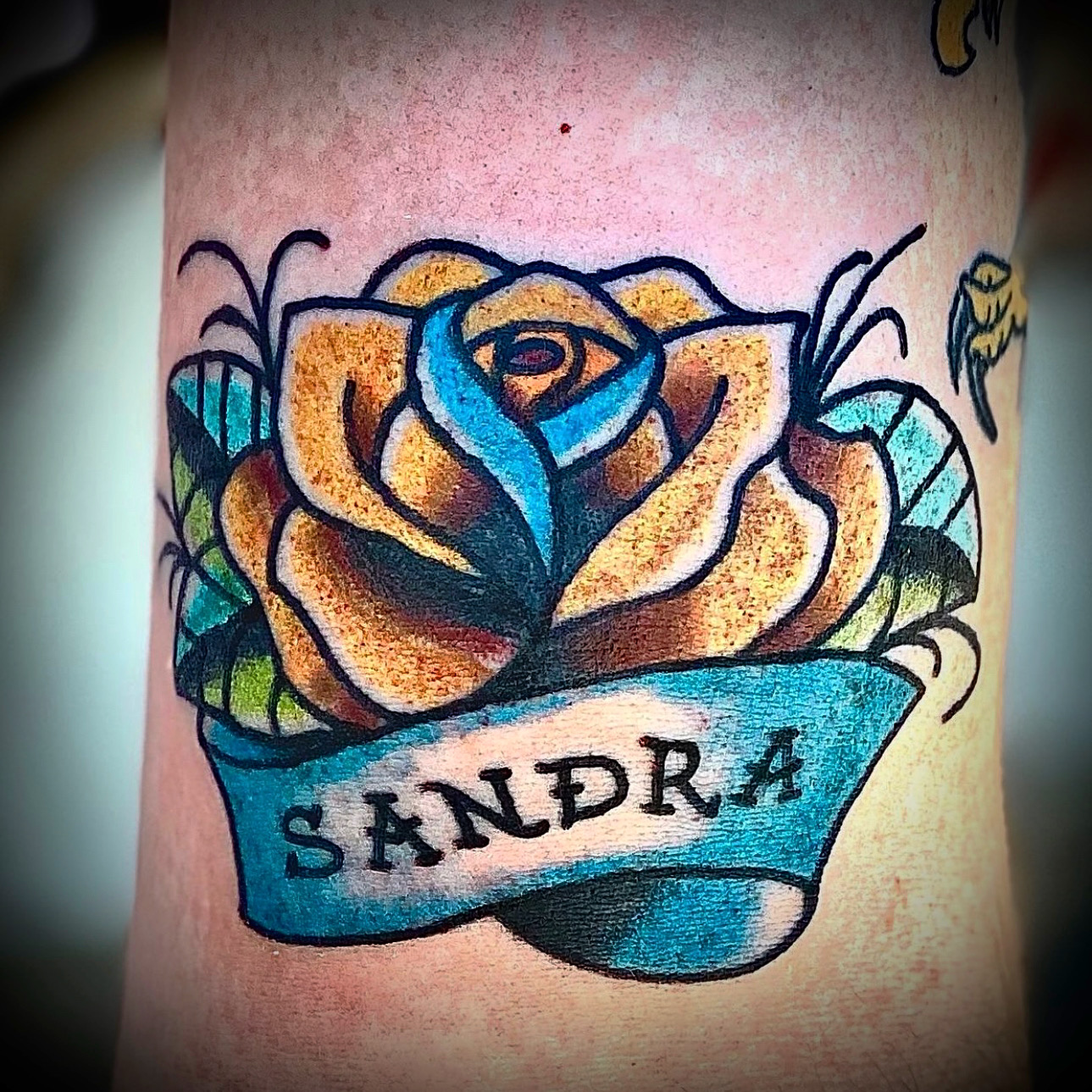 Tattoo of a name and flower from Dallas Tattoo artist