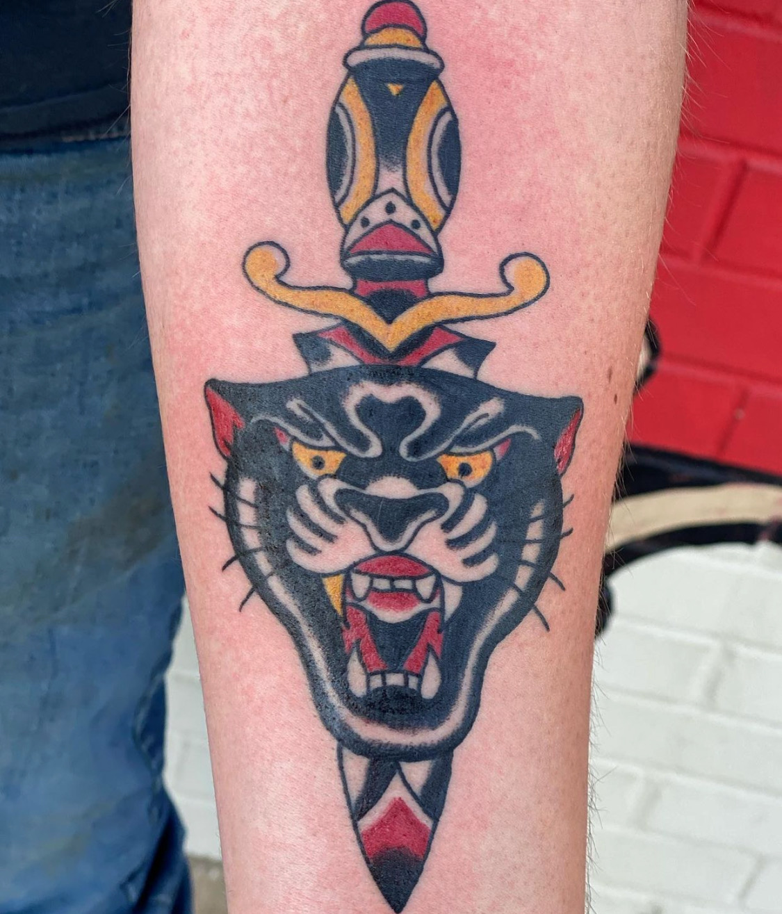 Black panther tattoo with a dagger from Dallas tattoo shop