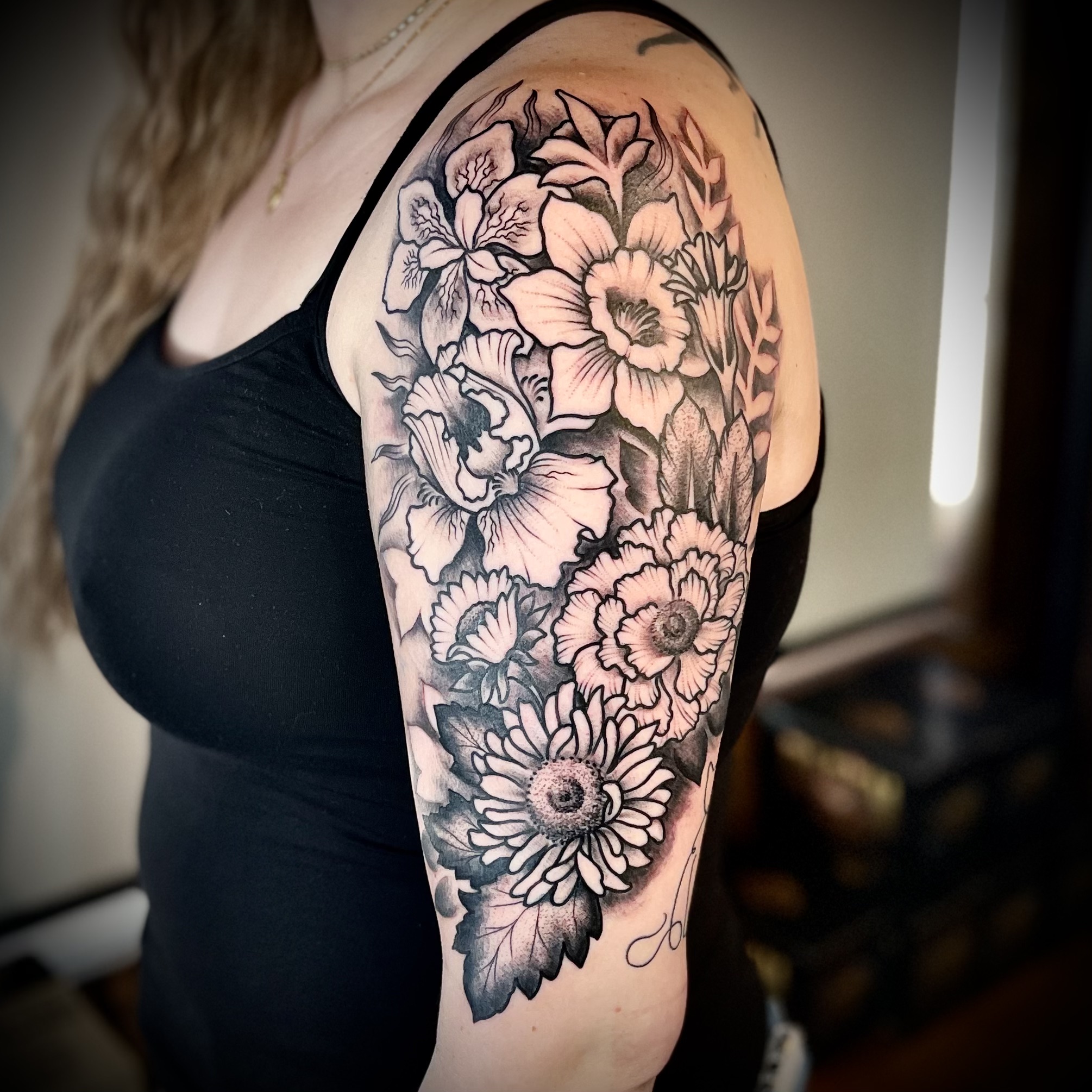 tattoo of flowers on a woman's shoulder from top DFW tattoo artist