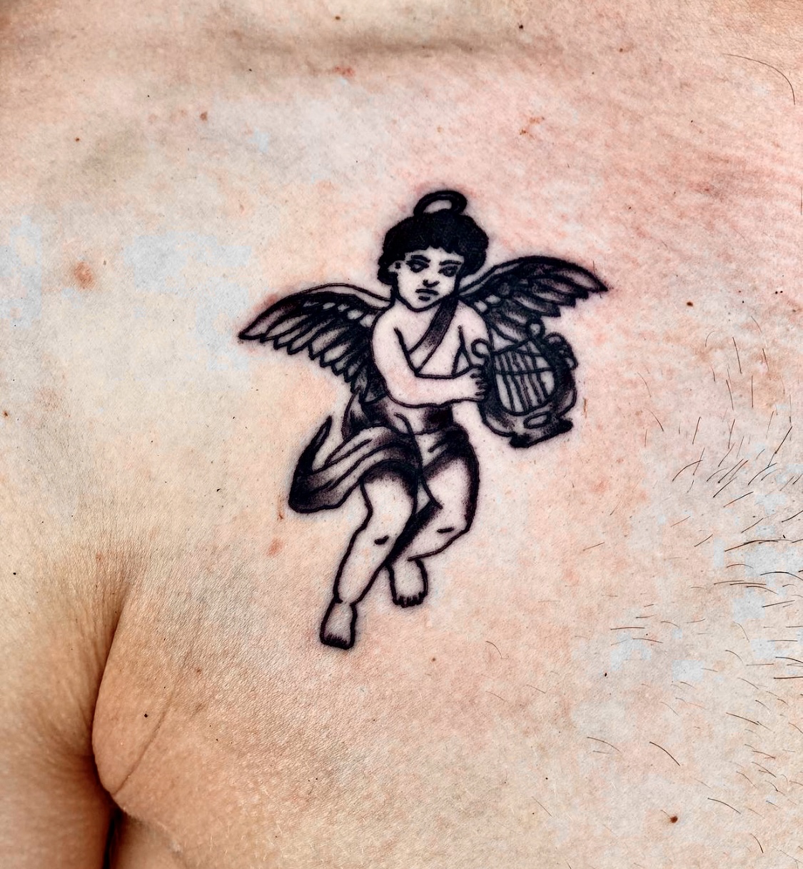 Tattoo of an angel on a mans chest