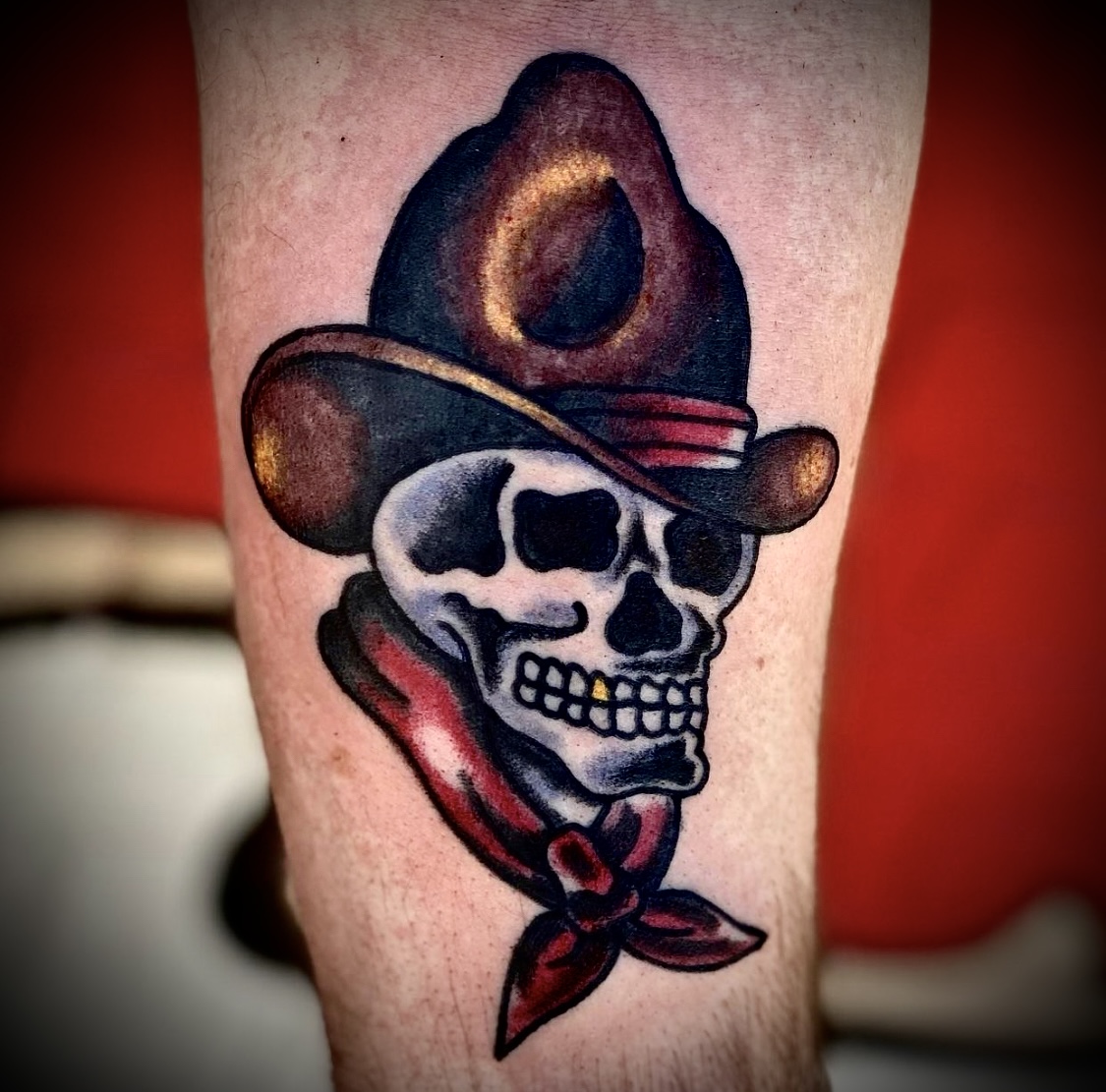 Tattoo of a skull in a cowboy hat