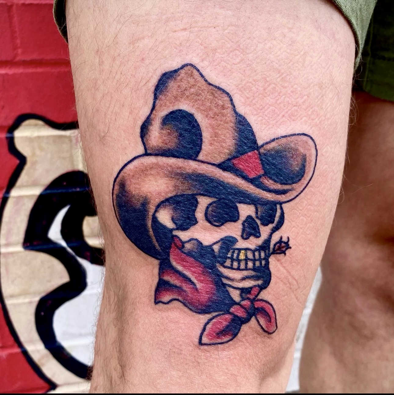 Tattooo of a skull with a cowboy hat on it