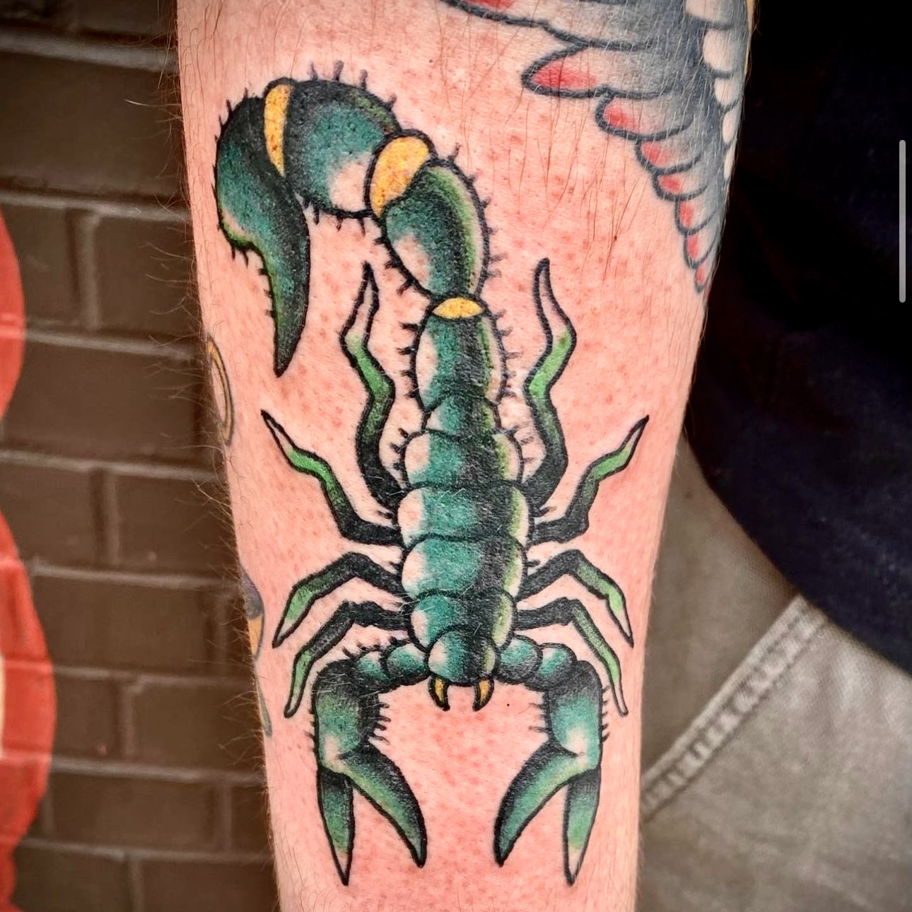 tattoo of a green scorpion