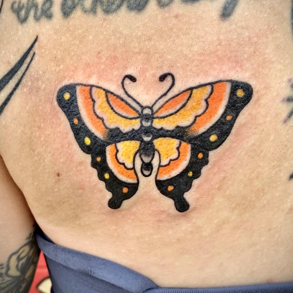 Tattoo of a orange and yellow butterfly