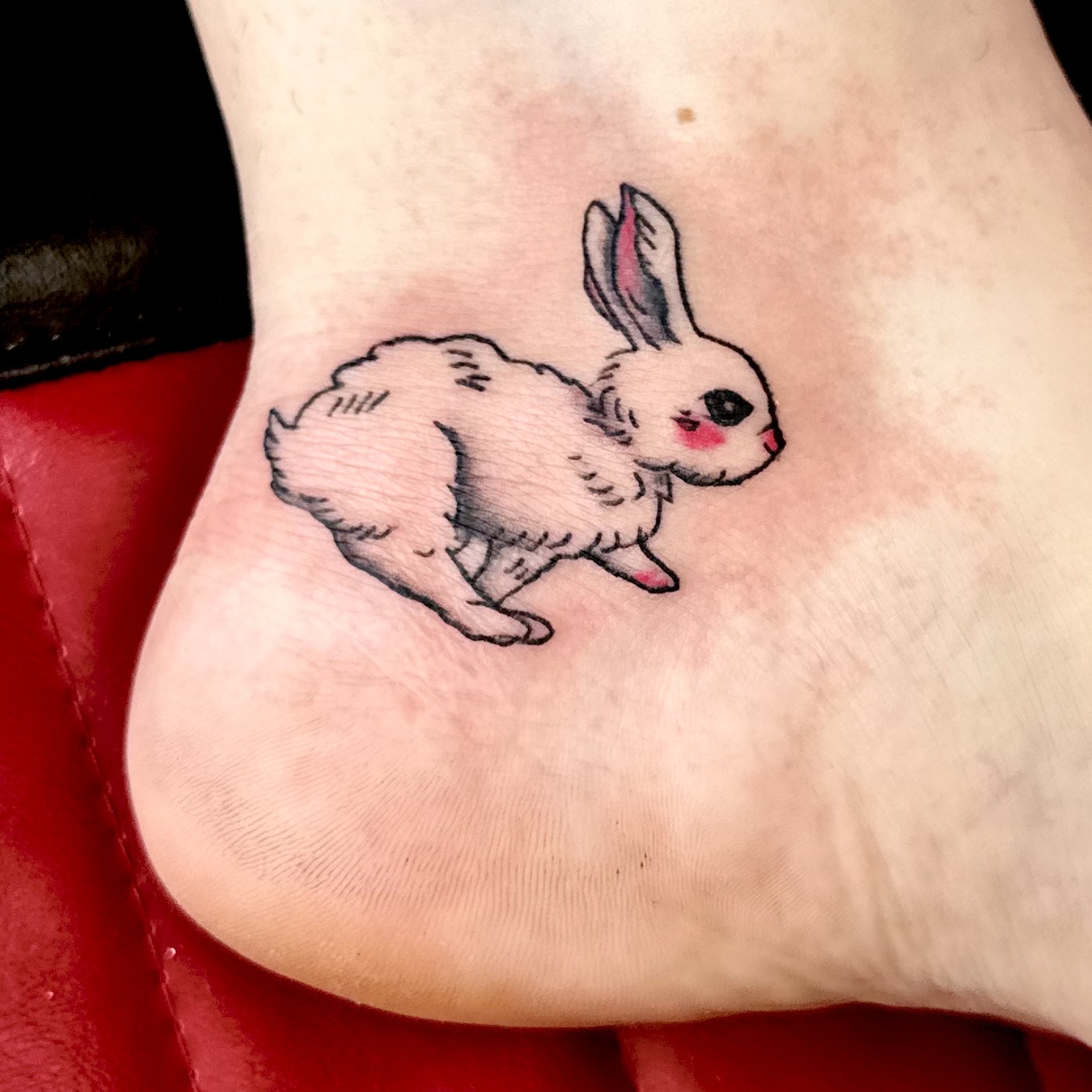 Small tattoo of a bunny on an ankle