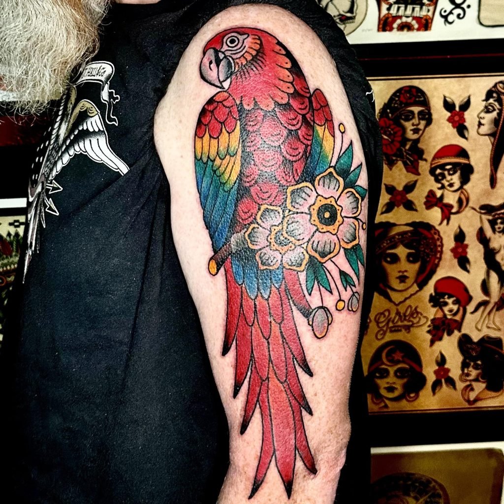 Common Tattoo Mistakes & How To Avoid Them colorful parrot tattoo arm - March 28, 2024 - Tattoo Artist - https://lamarstreettattooclub.com/blog/